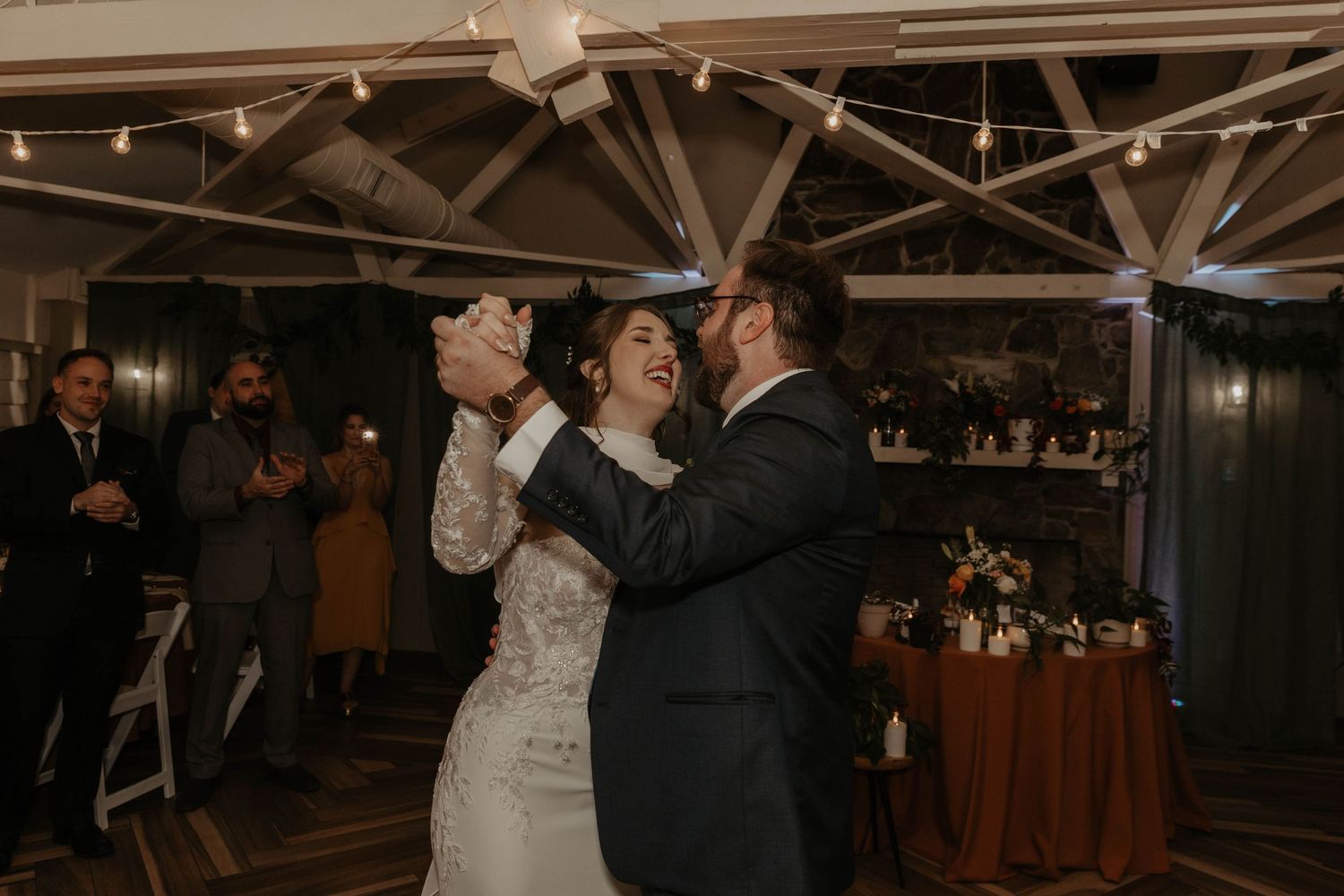 Joyful bride and groom sharing first dance under string lights at Glen Manor House wedding reception. 

top rated RI wedding photographer