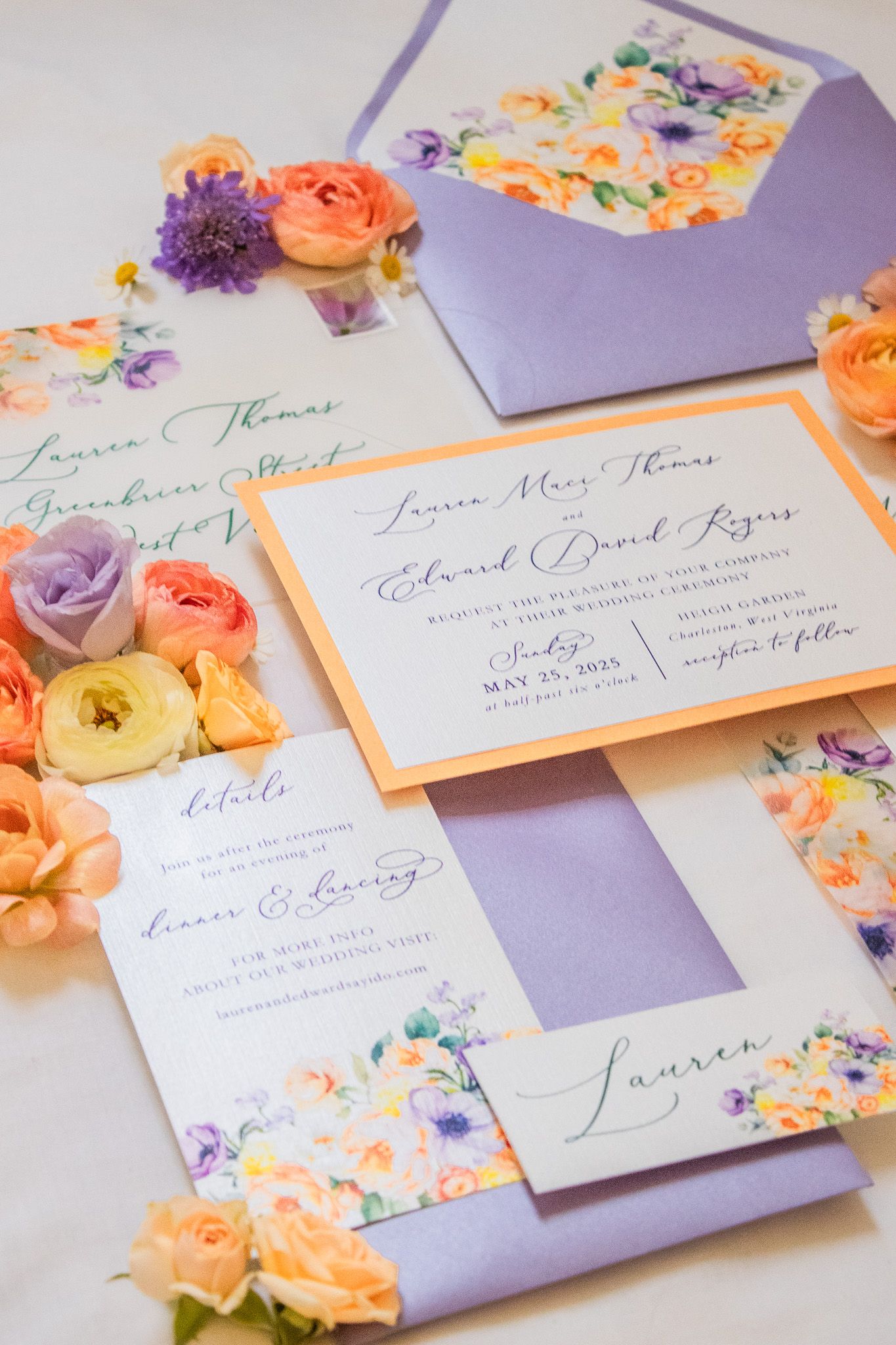 Wedding invitation suite featuring purple and peach floral designs with elegant calligraphy on lavender and white paper.