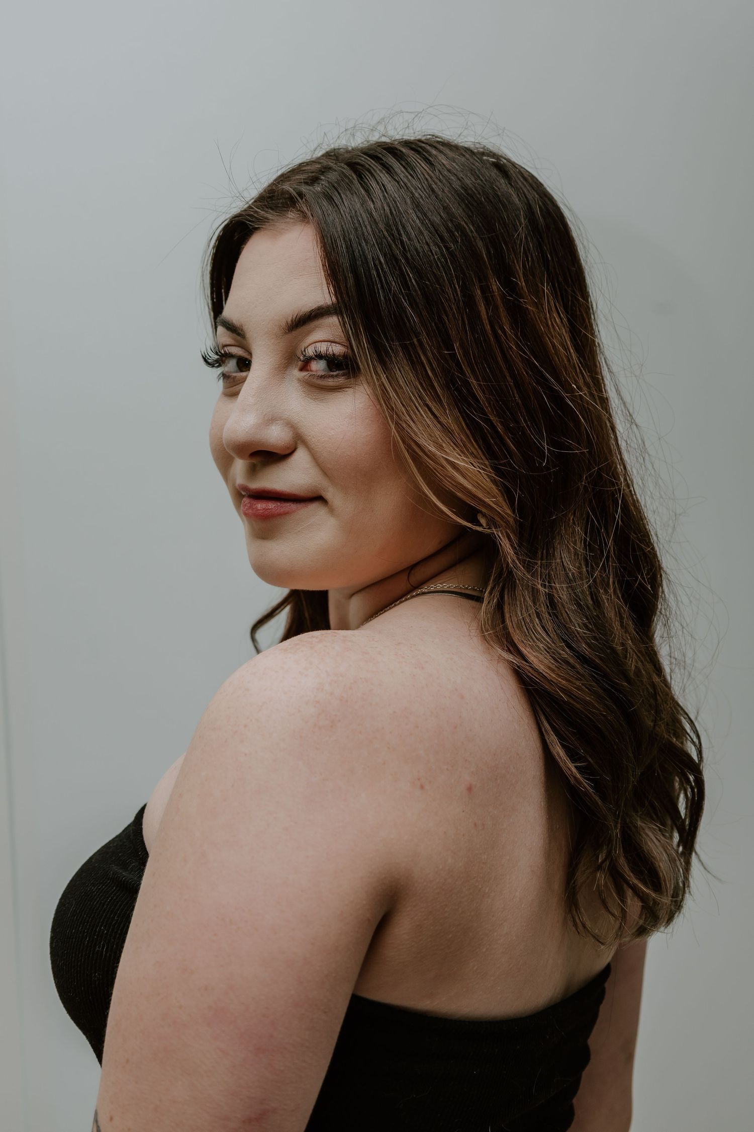 Artistic portrait series showing different angles and poses against a light gray background.