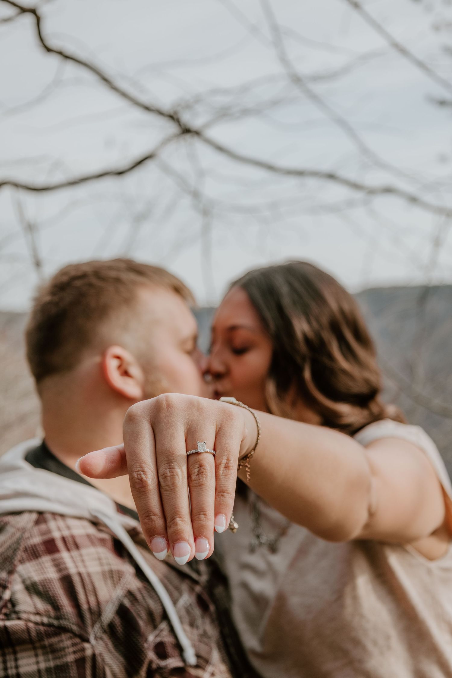 A romantic series of close-up photos showing a couple embracing and displaying an engagement ring.