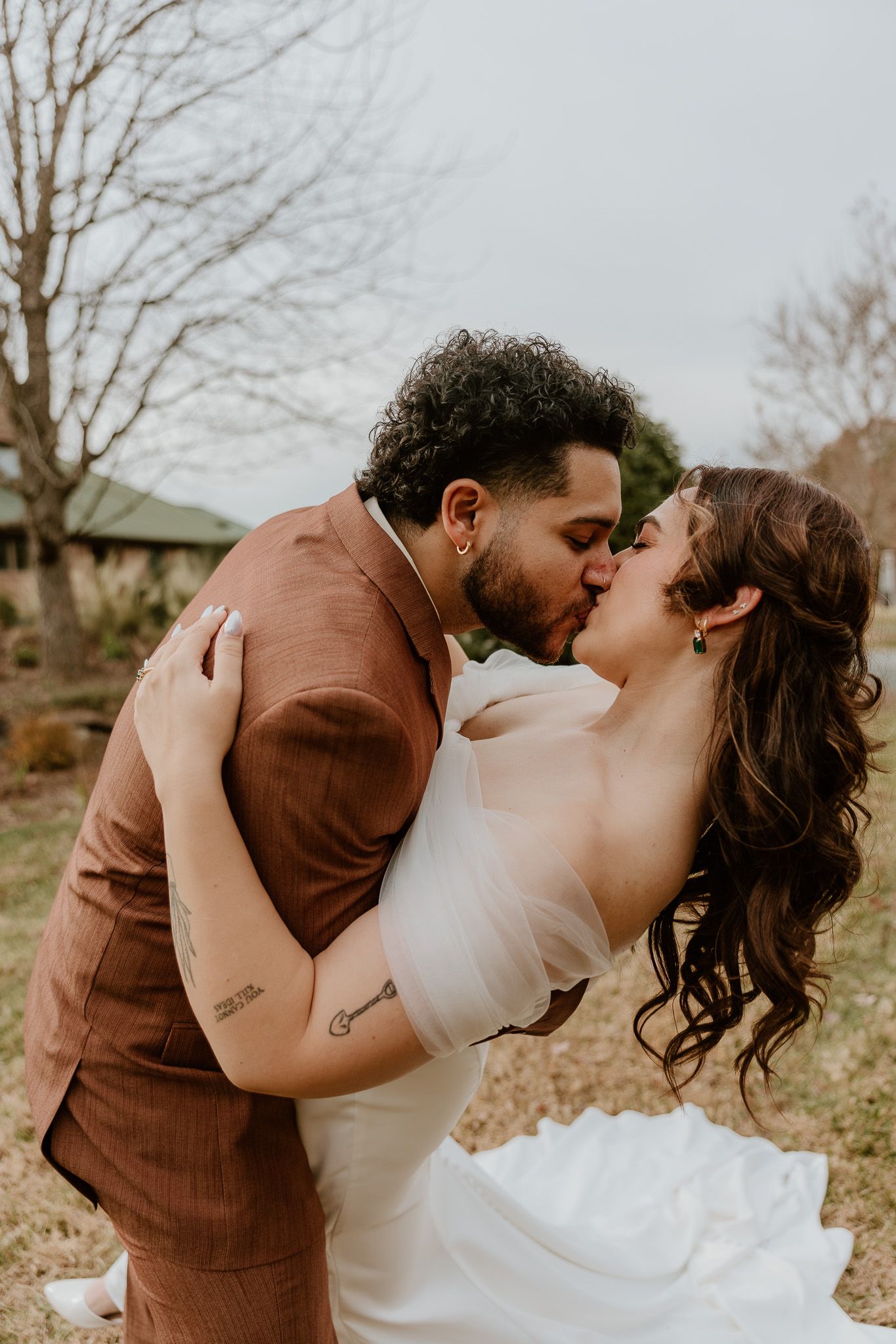 A romantic wedding moment captured in a sequence of artistic dips and kisses outdoors.