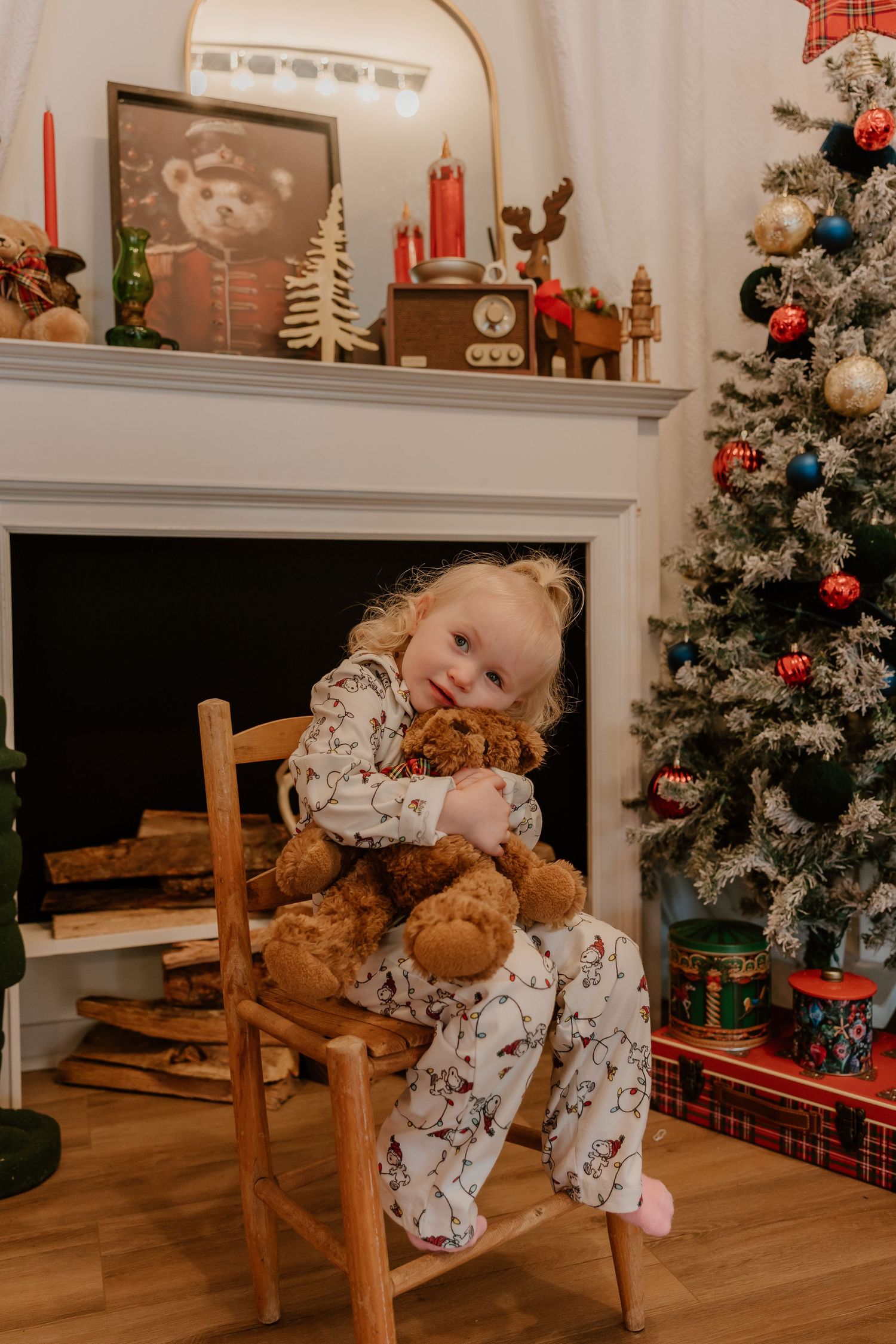 Decorated Christmas trees and holiday decor create a cozy festive atmosphere in a warm-toned living room.