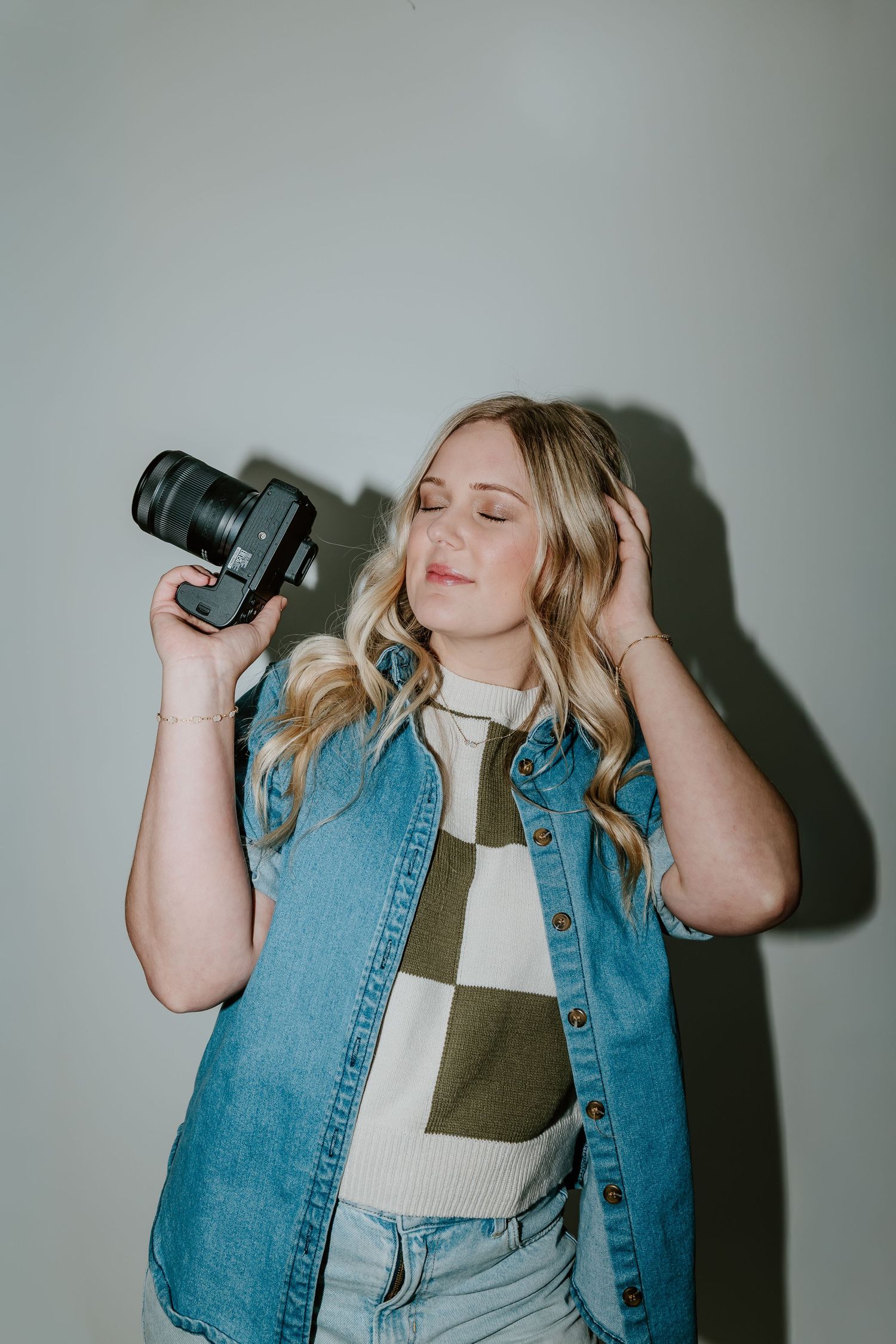 Person in denim jacket and white shirt drinking from dark bottle against light background in sequence of photos.