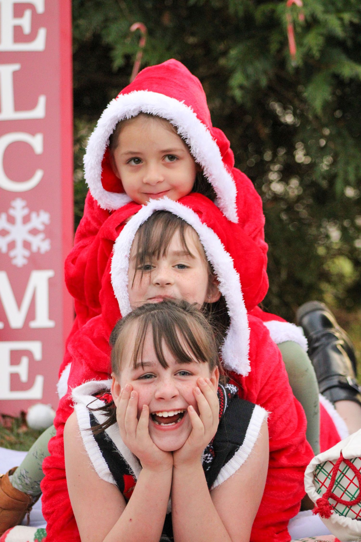 A series of festive holiday photos showing someone in red and white Santa hats making playful expressions.