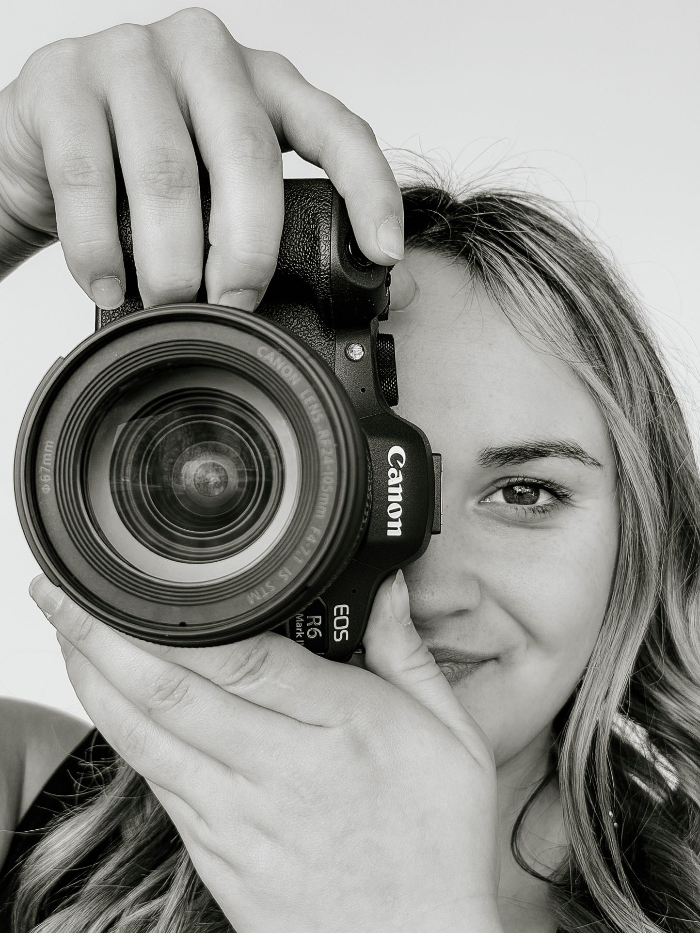 A sequence of four black and white photos showing someone taking pictures with a camera lens covering their eye.