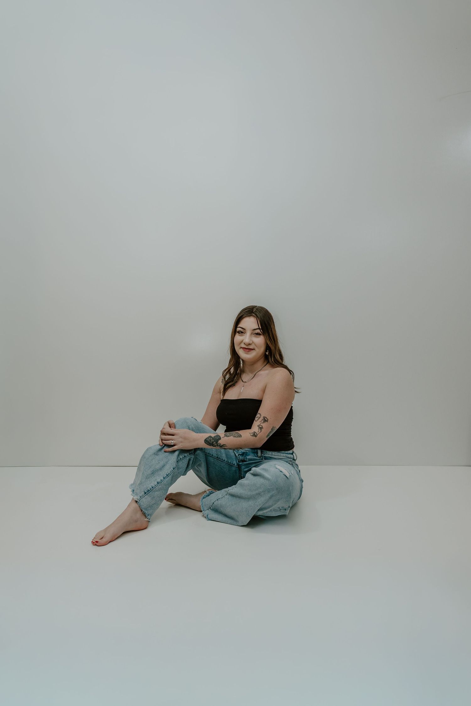 A series of minimalist studio portraits showing a person in casual clothing against a light gray background.
