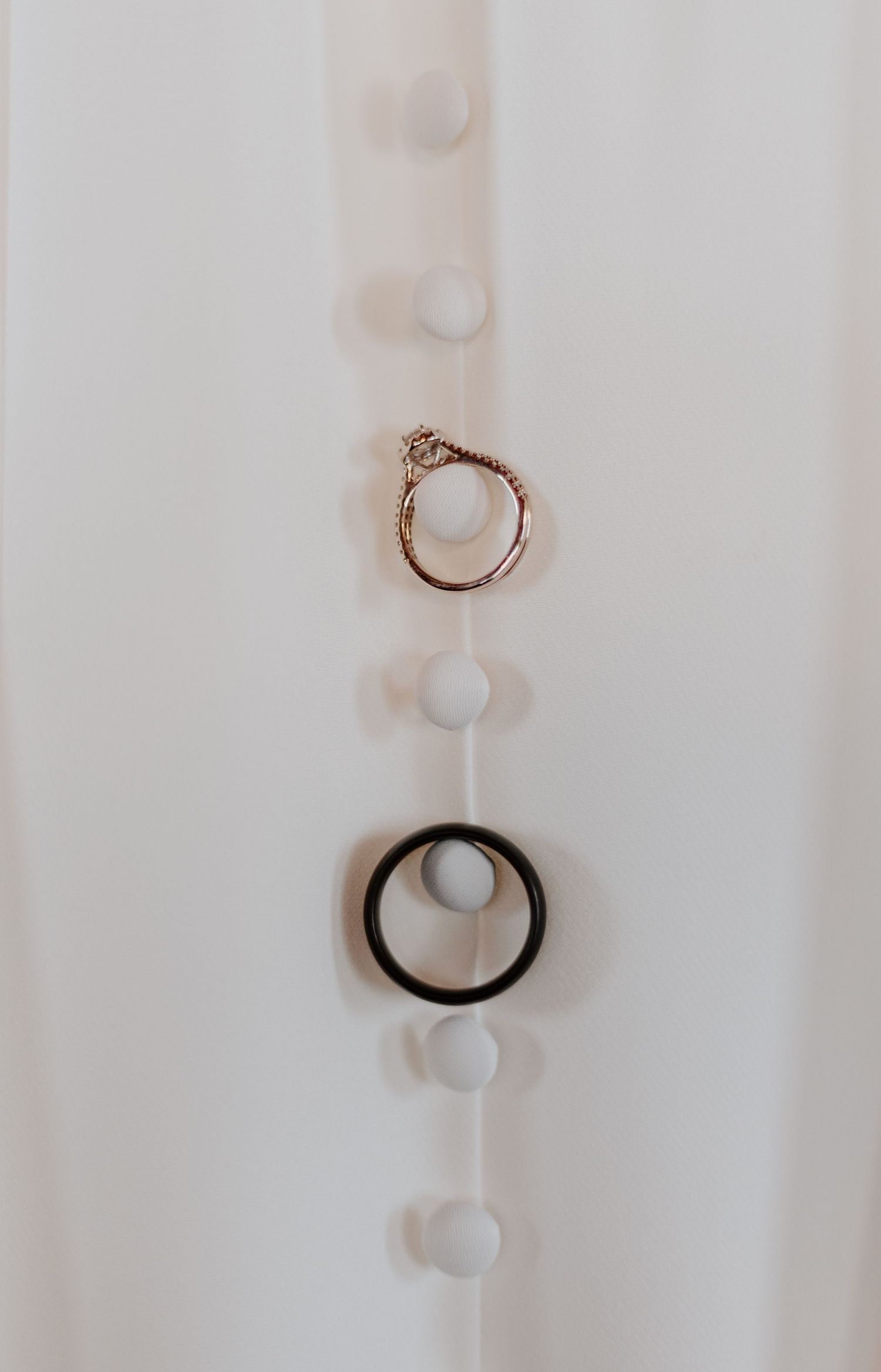 A series of minimalist white abstract shapes with curved lines and shadows creating a soft, ethereal composition.