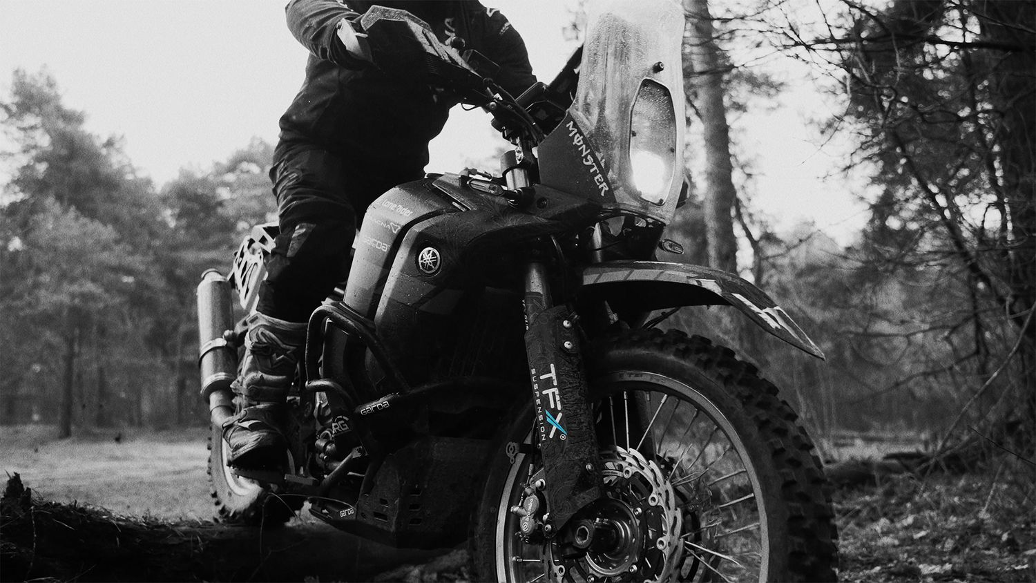 A vintage black and white photo sequence showing a person riding and falling off a motorcycle in a wooded area.