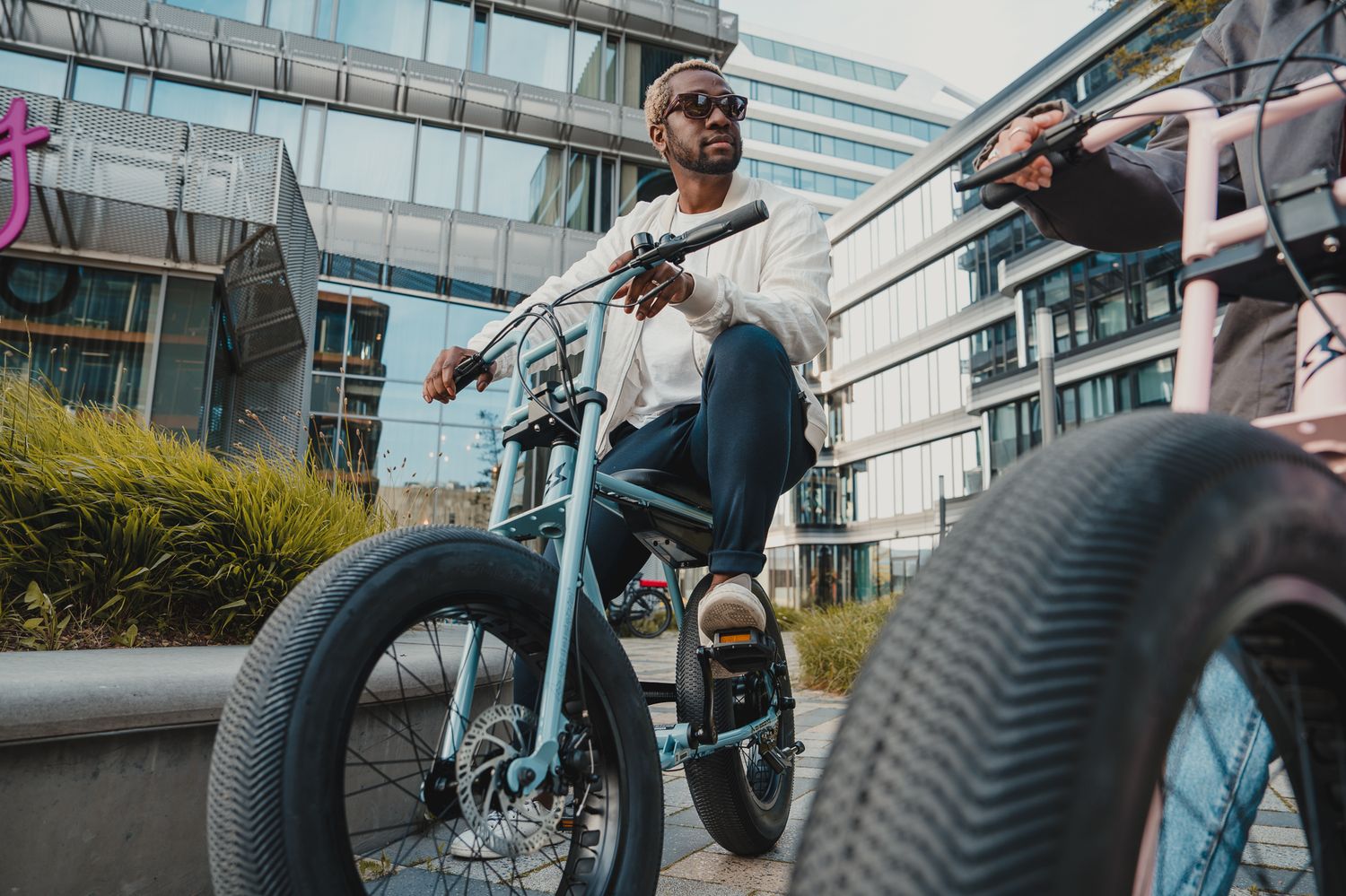 Close-up of fat tire electric bike wheel during urban street performance.