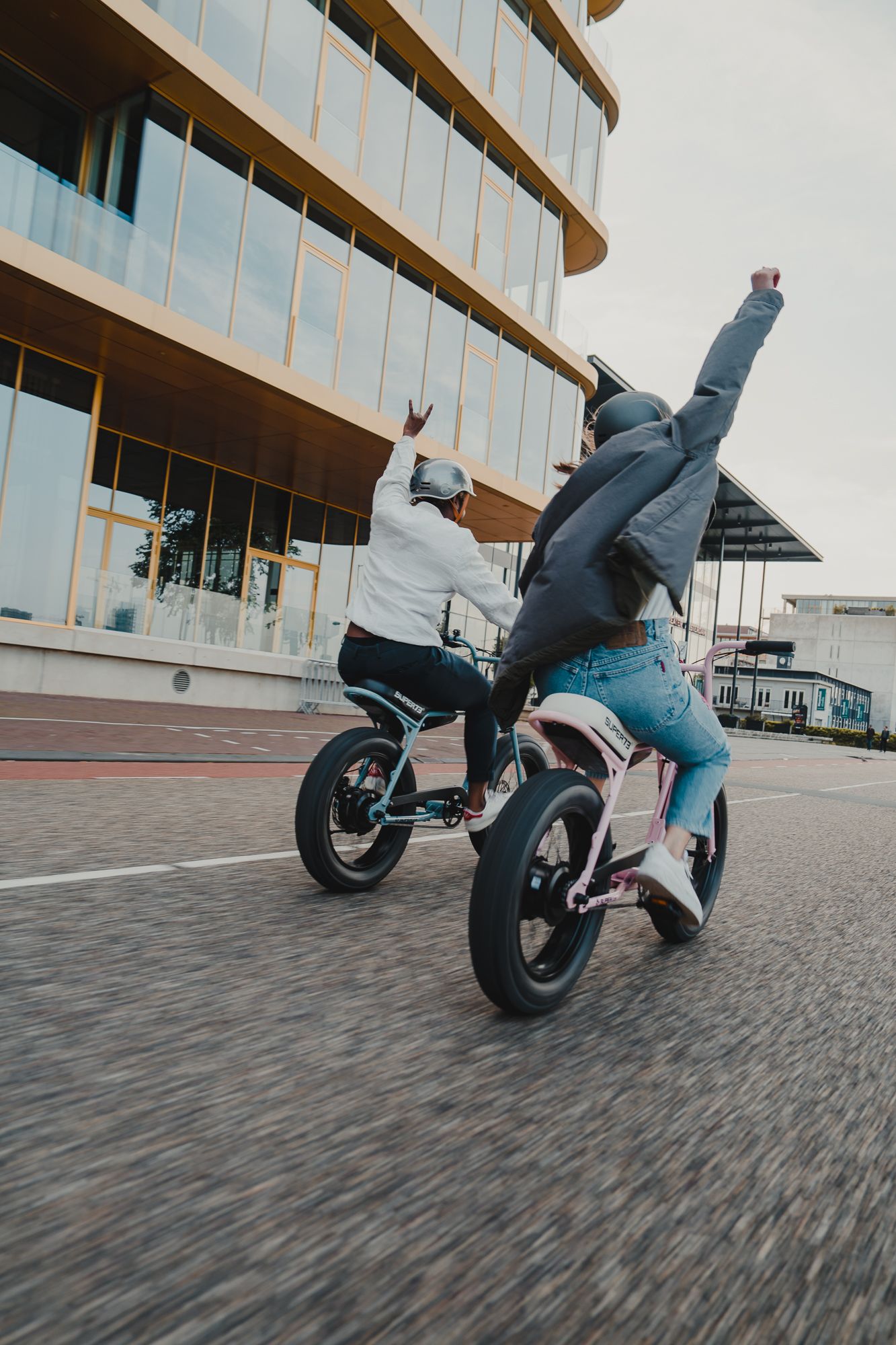 Dynamic low-angle shot of electric bike in motion on cobblestone pavement.