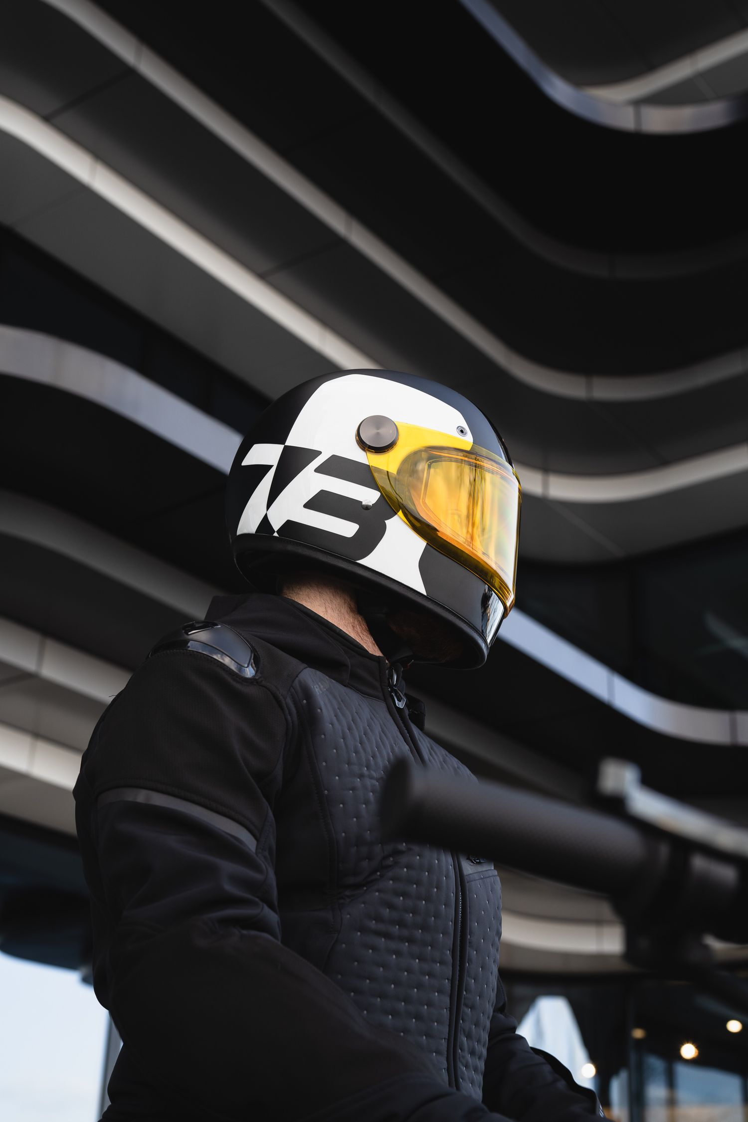 Profile view of motorcycle helmet with distinctive black and yellow design.