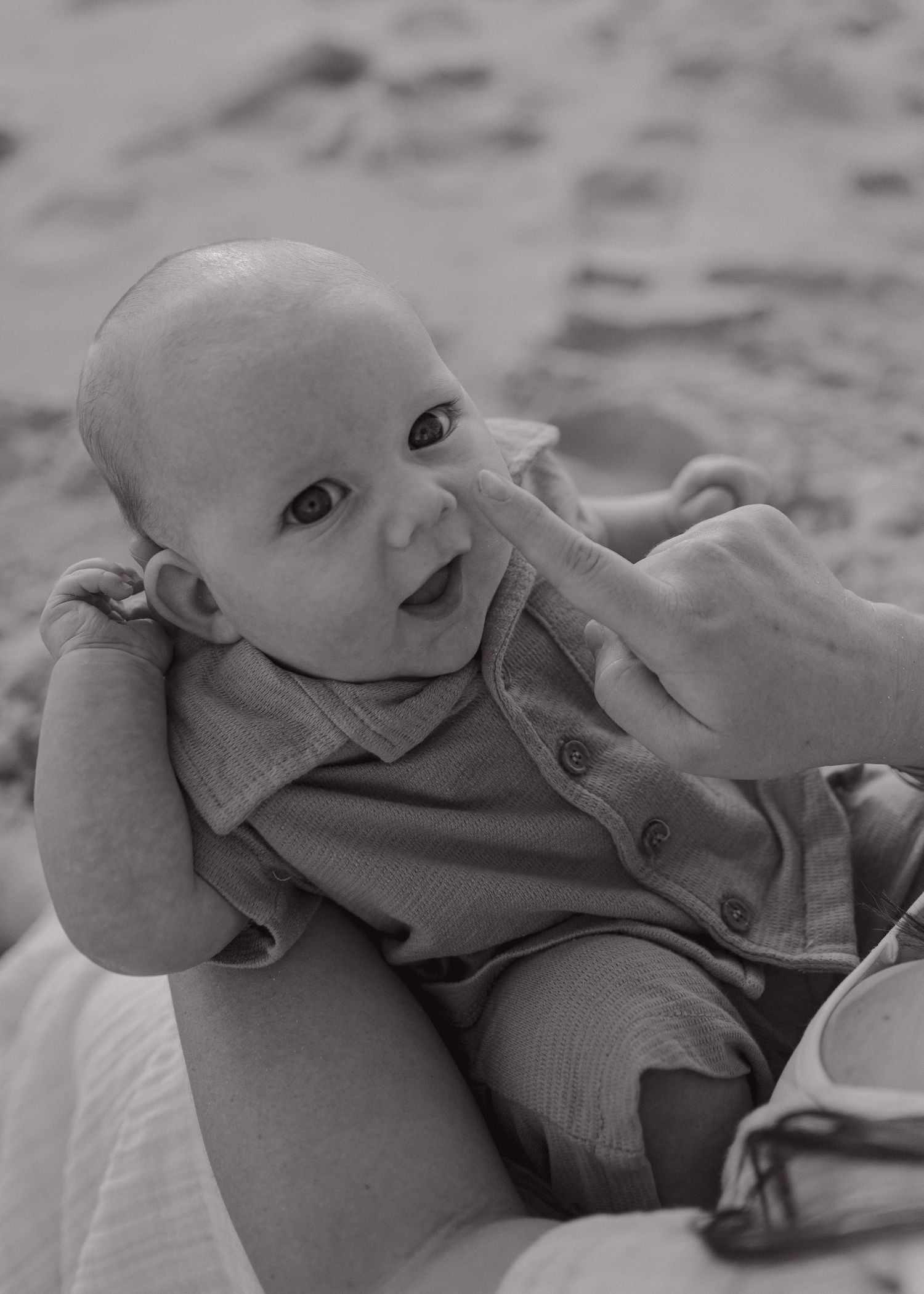 Close-up black and white portraits of a baby showing various expressions.