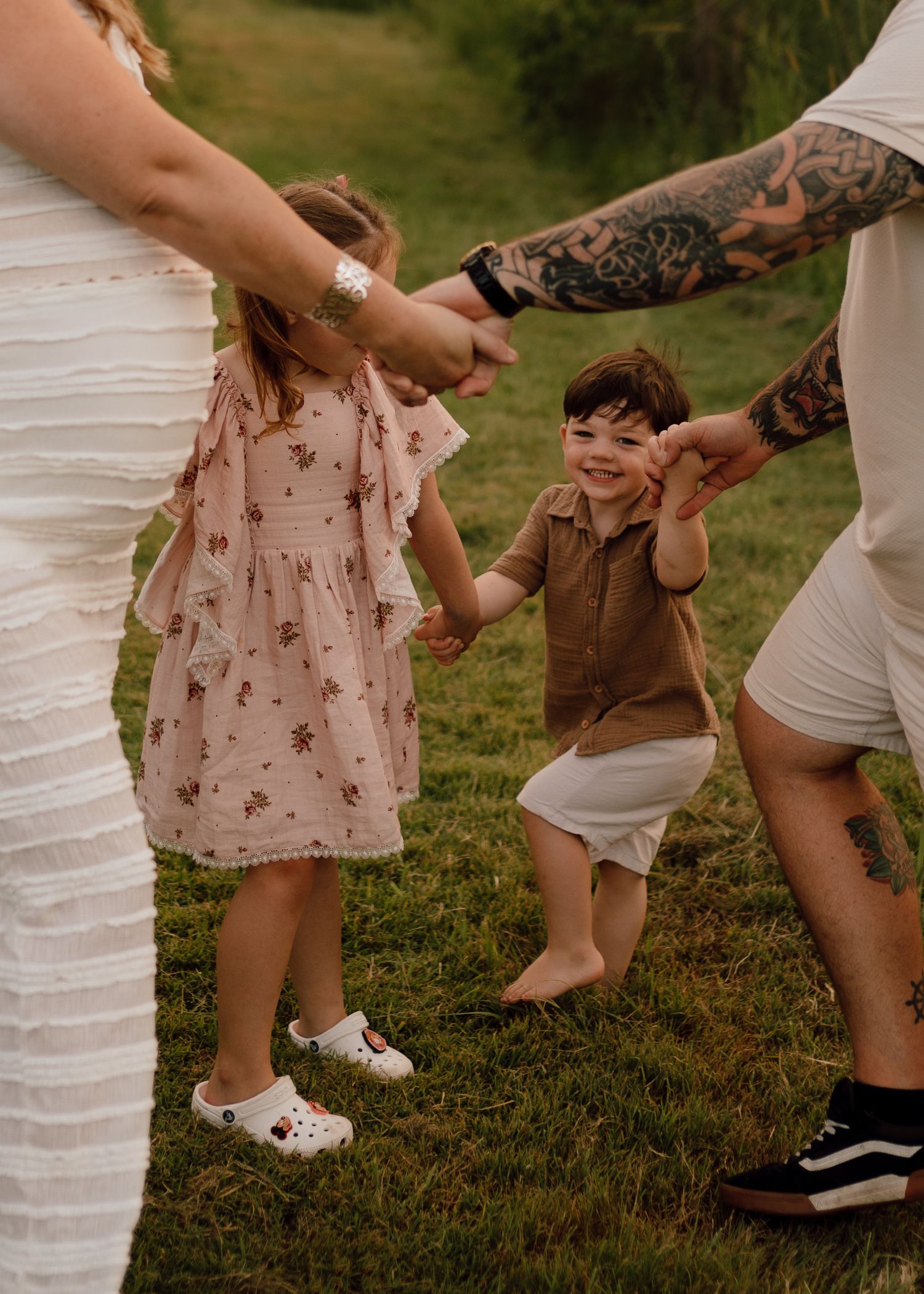 A series of cropped photos showing feet and legs dancing or moving on grass in casual summer attire.