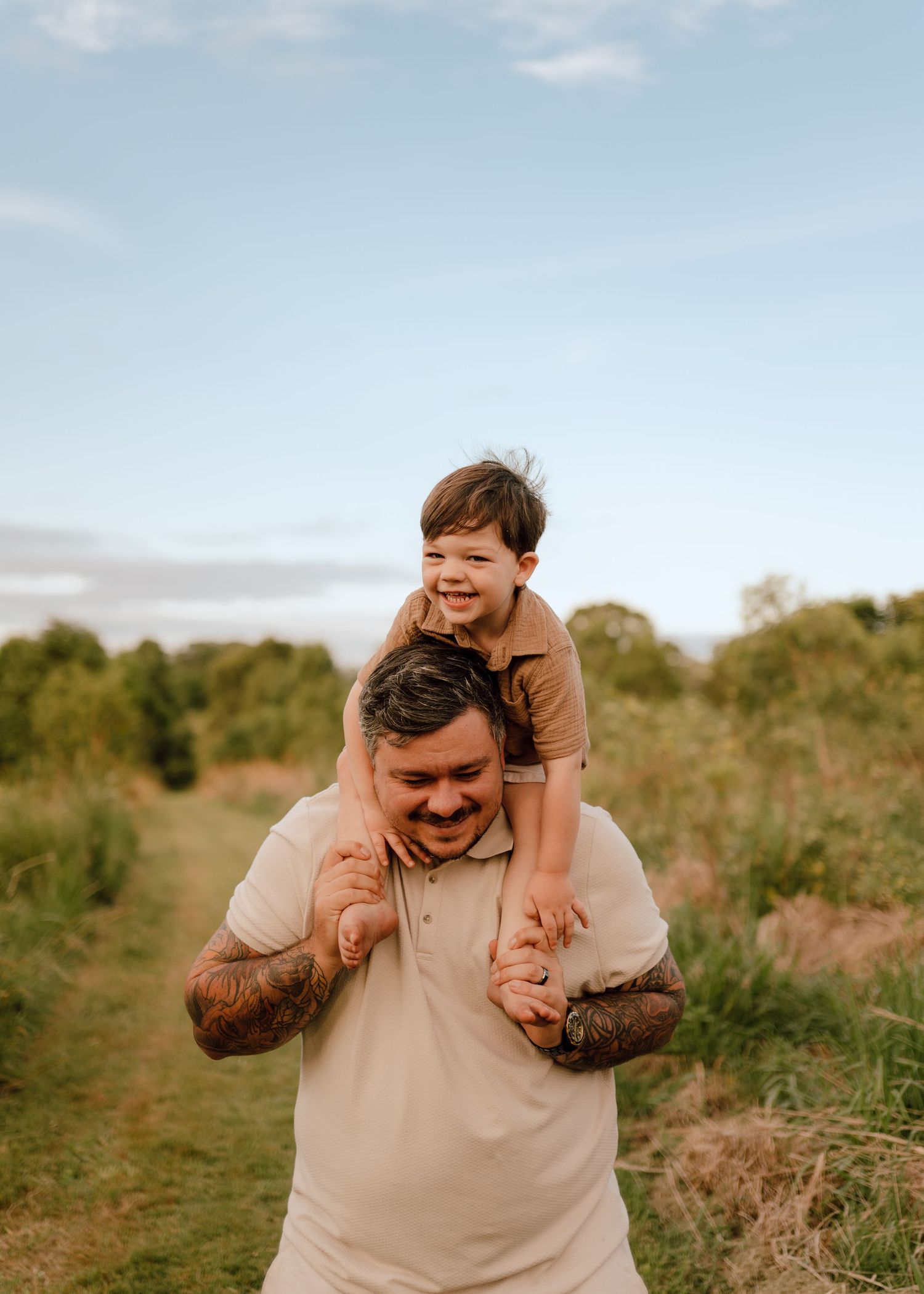 A playful family moment captured in a series of candid shots in a natural outdoor setting at golden hour.