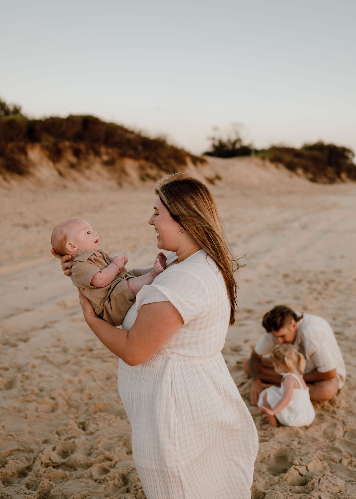 Joyful moments shared between family members on a sandy beach.