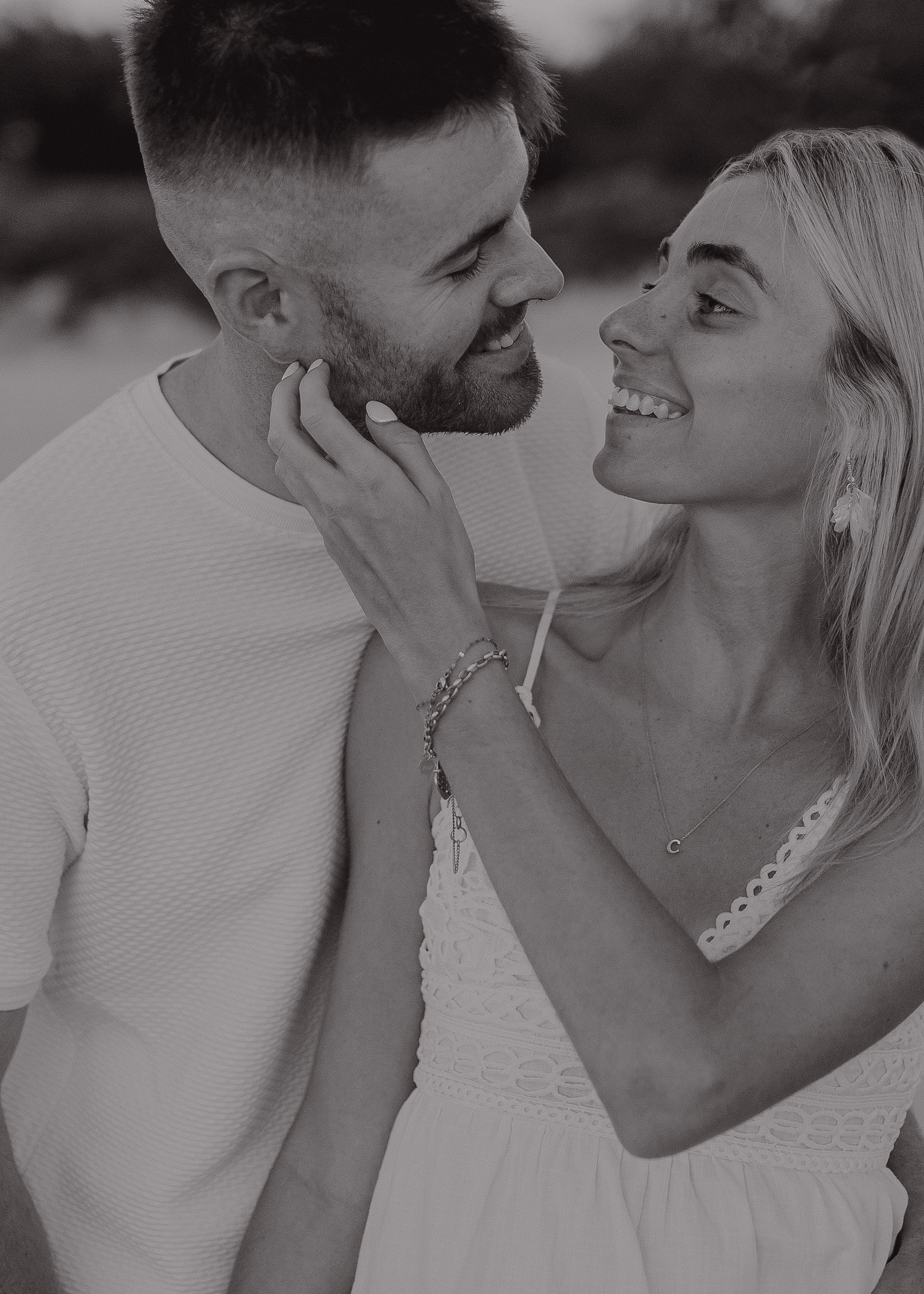 A romantic black and white photo series showing a couple sharing tender moments and kisses.