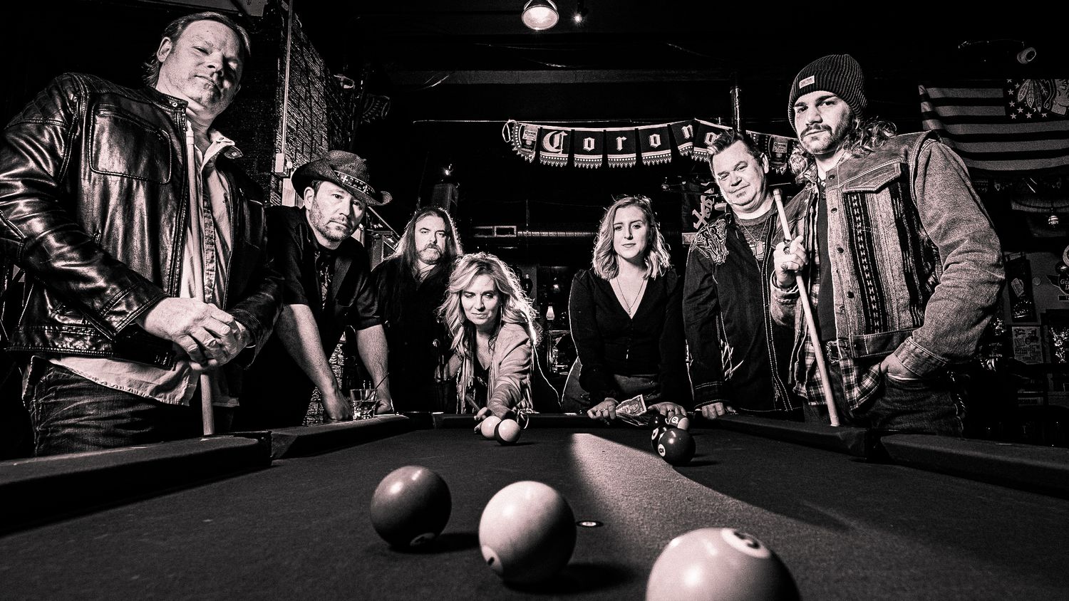 Panoramic black and white shot Chicago area cover band Whiskey Road of people in a bar setting.