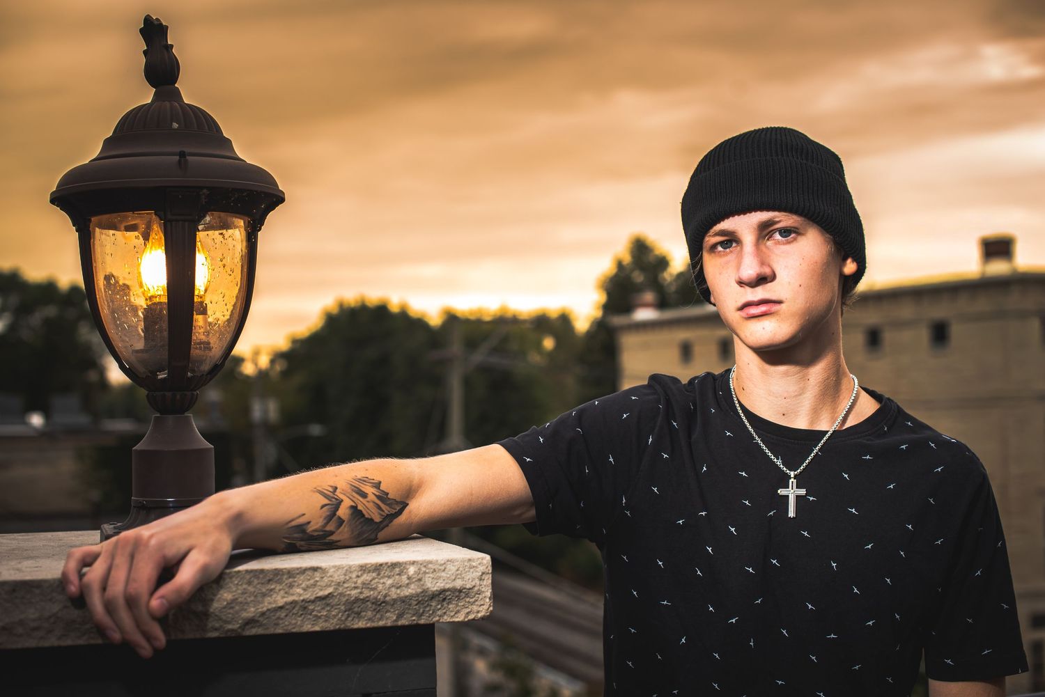 Portrait series at sunset with dramatic golden lighting and urban backdrop.