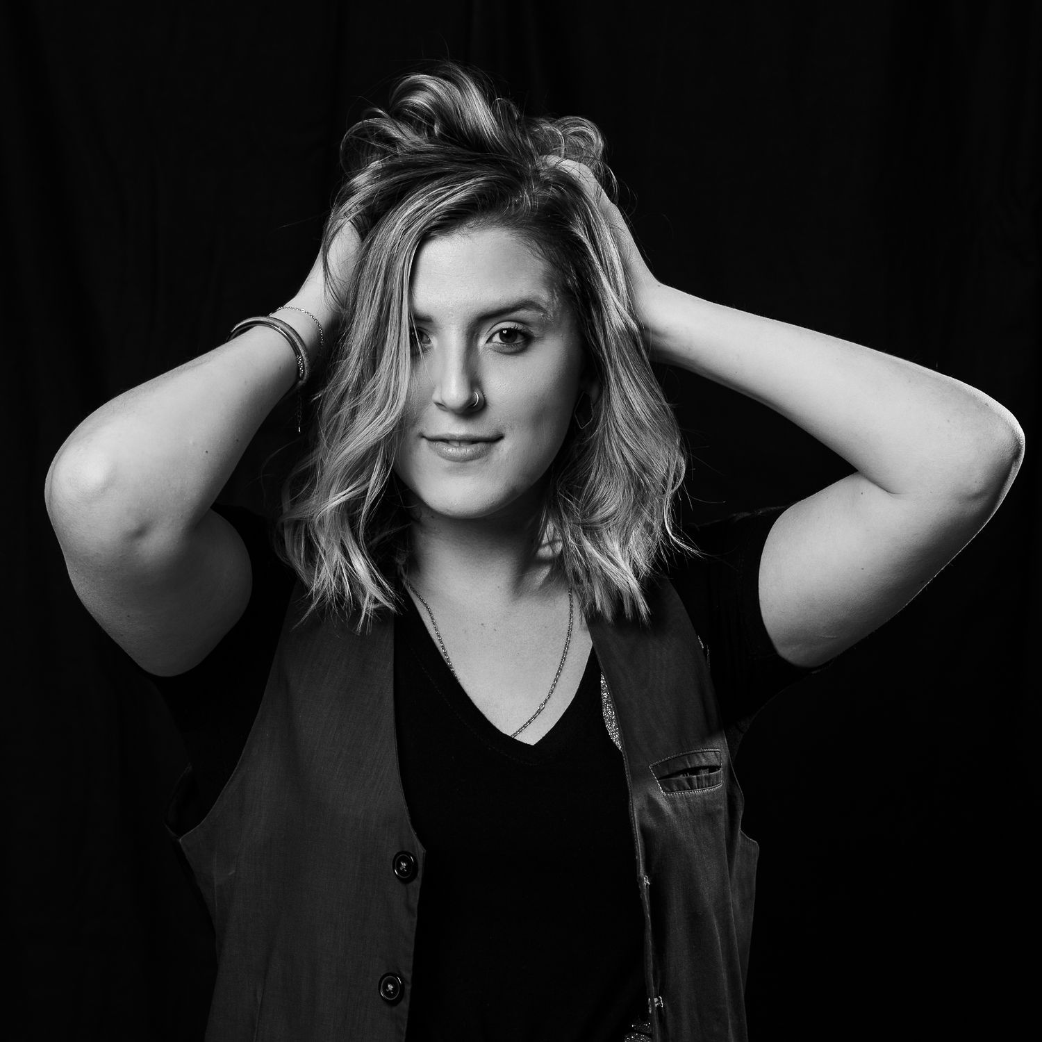Black and white portrait series showing dynamic poses against dark background.