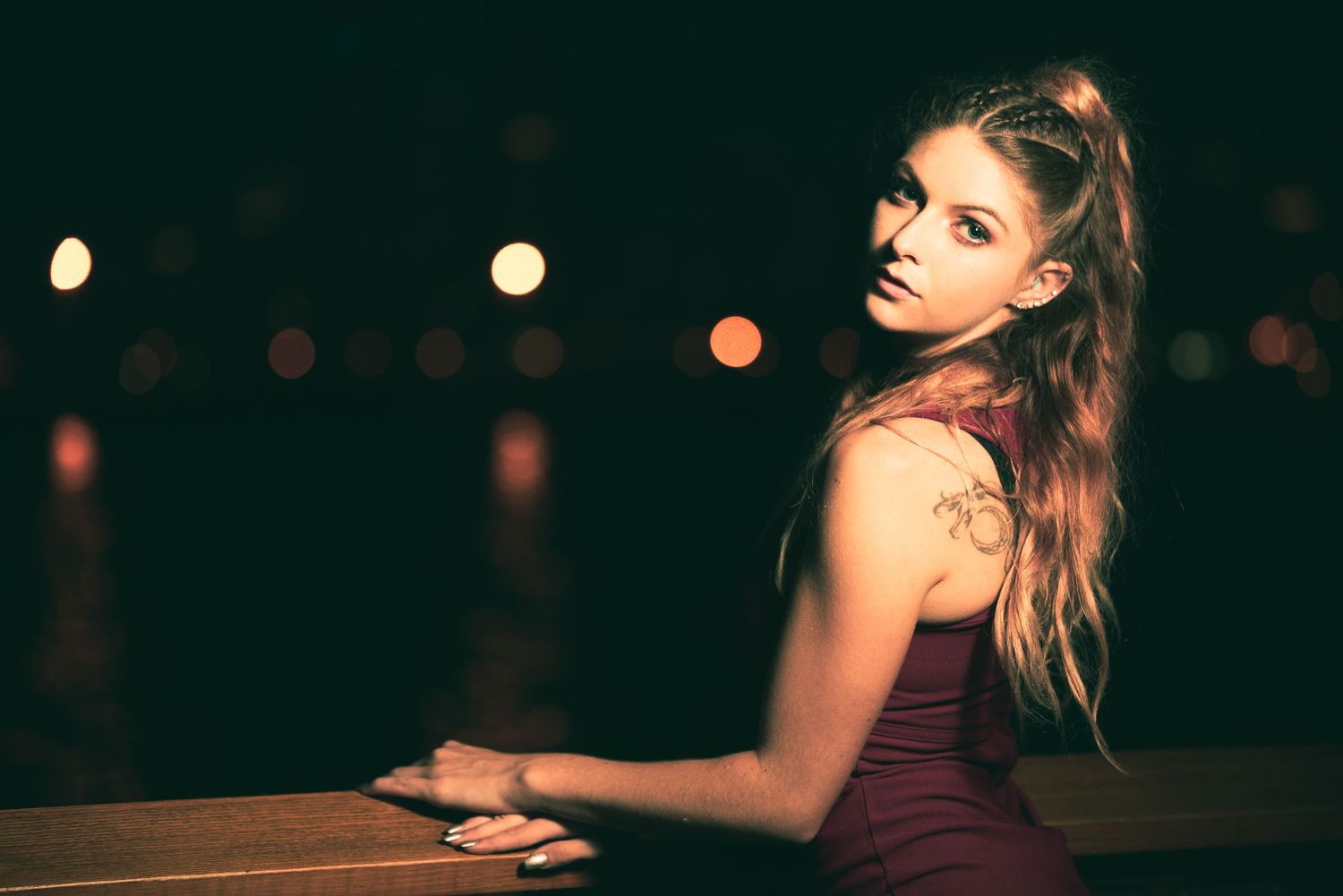 Atmospheric nighttime portraits with bokeh lights in background.