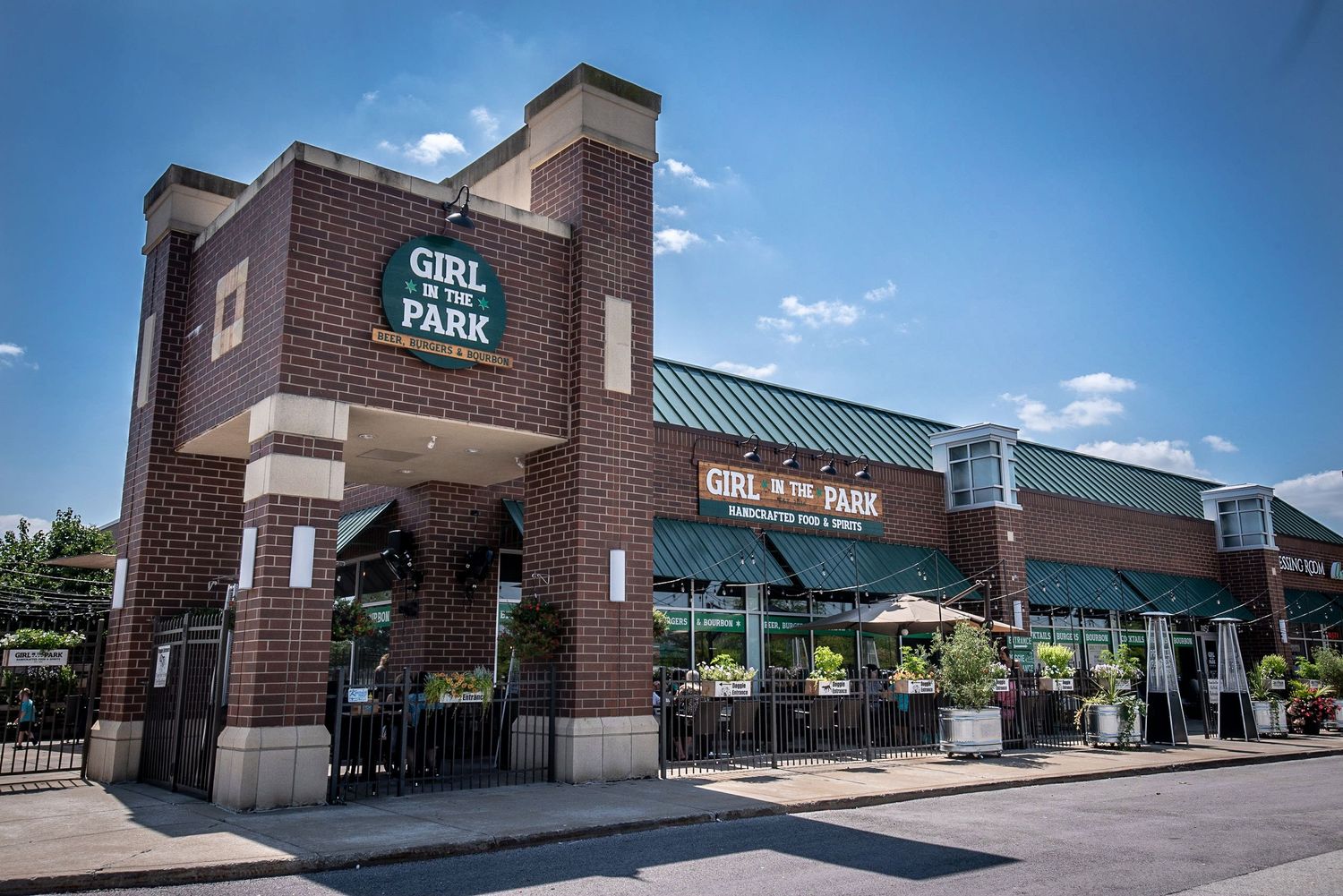 Exterior view of modern brick retail shopping center with storefronts.