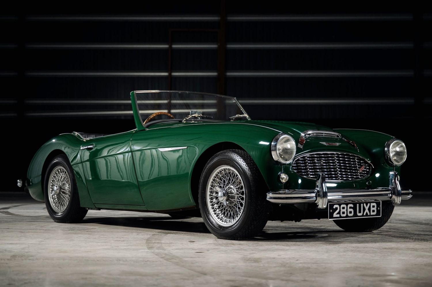 Vintage green Austin-Healey 100 classic sports car with wire wheels. The Motorist Collection