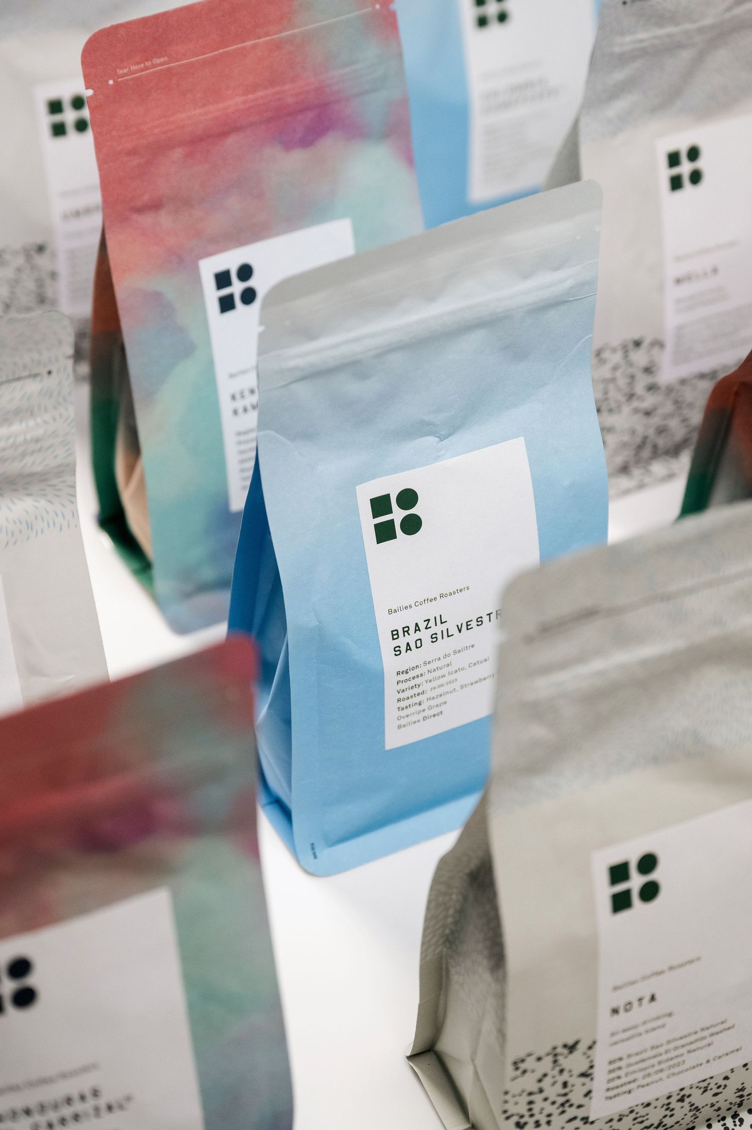 Collection of specialty coffee bags including Brazil Sao Silvestre displayed on a white surface. Bailies Coffee Roasters