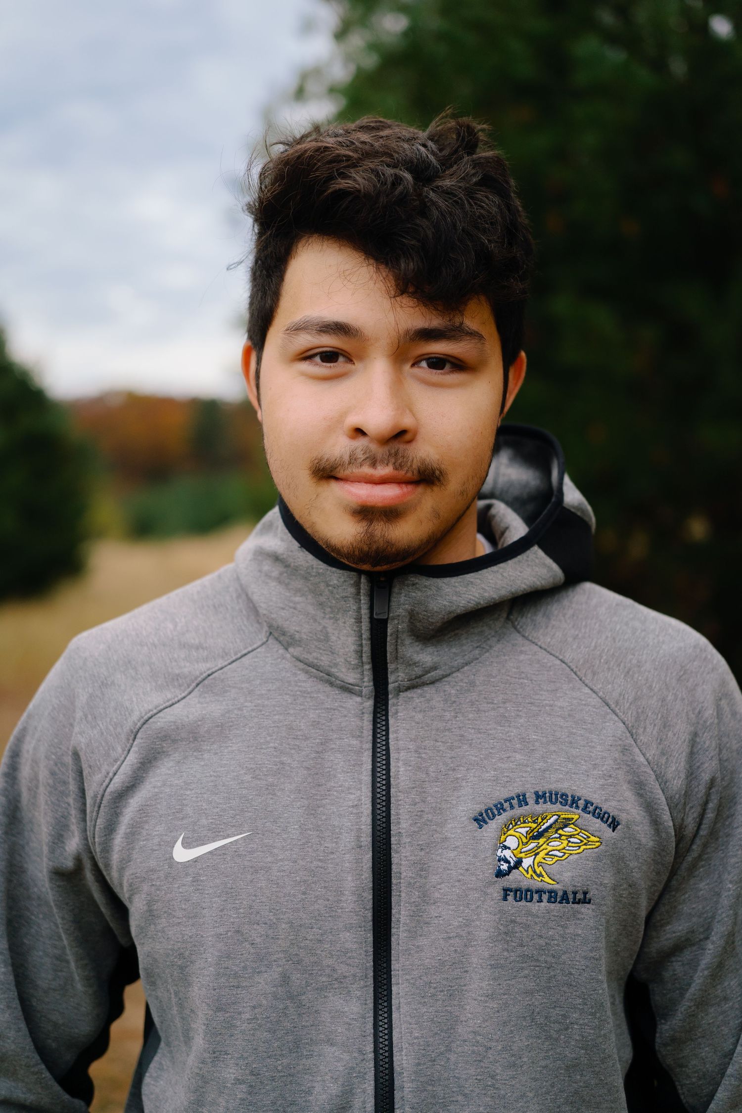 Series of close-up portraits showing a person in a grey Nike athletic hoodie.