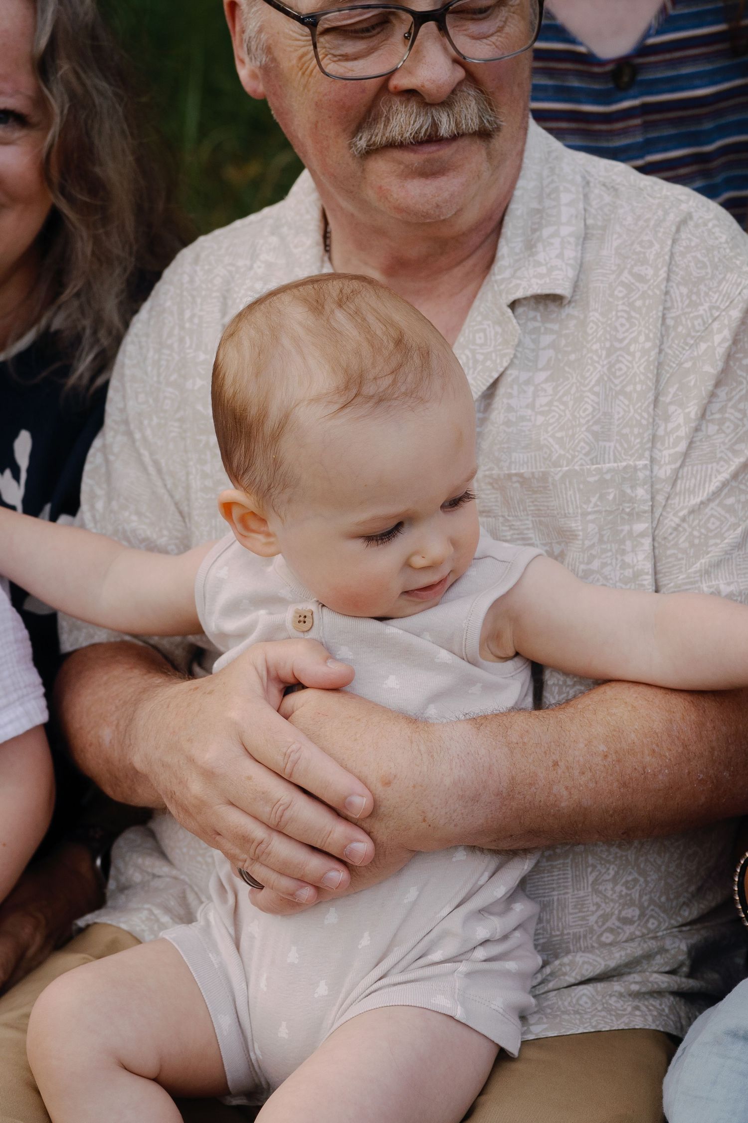 Close-up shot of family members sitting close together showing warmth and connection.