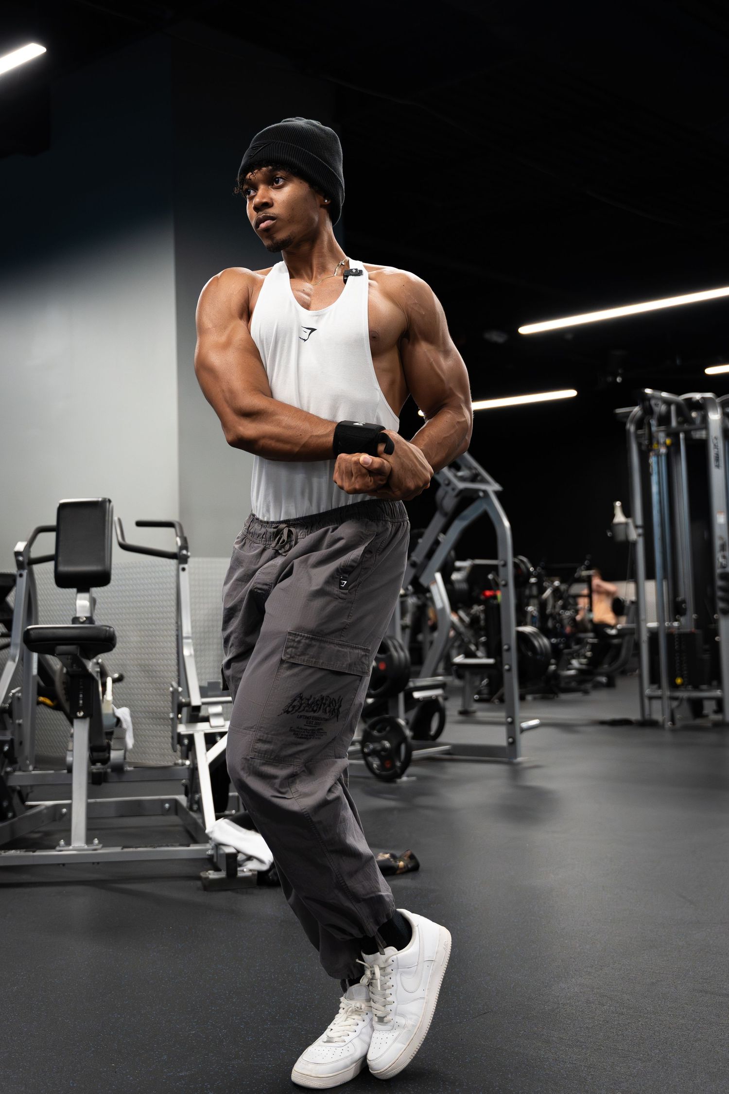 Full body picture of man posing in gym.