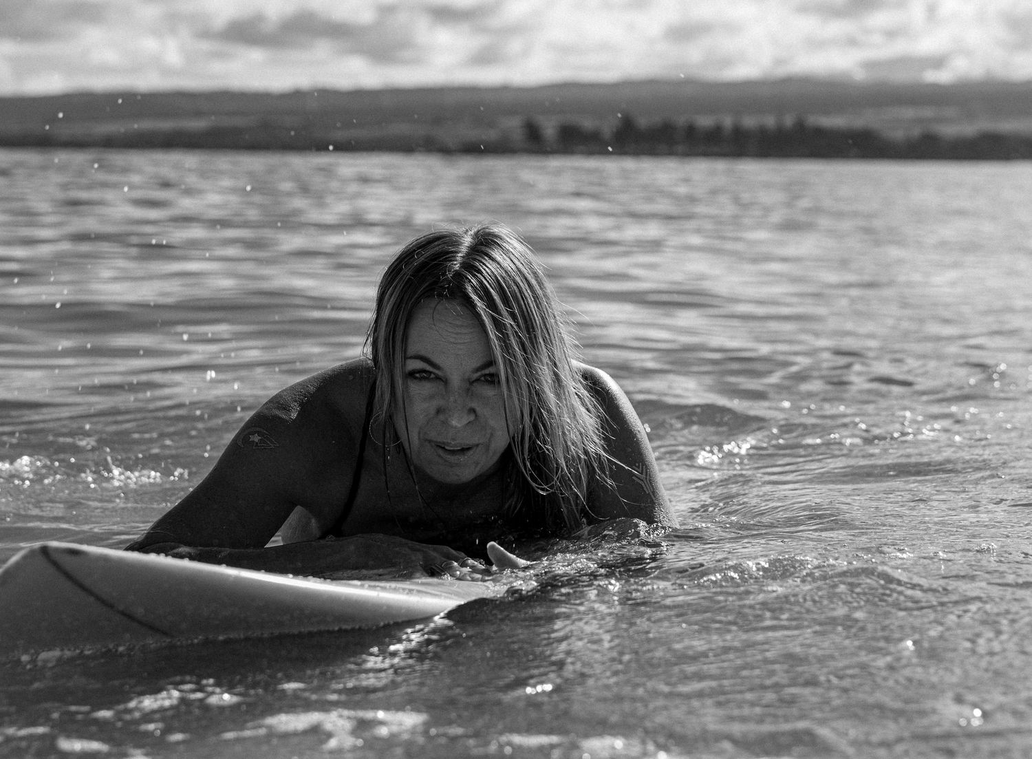 Woman relaxing on surfboard