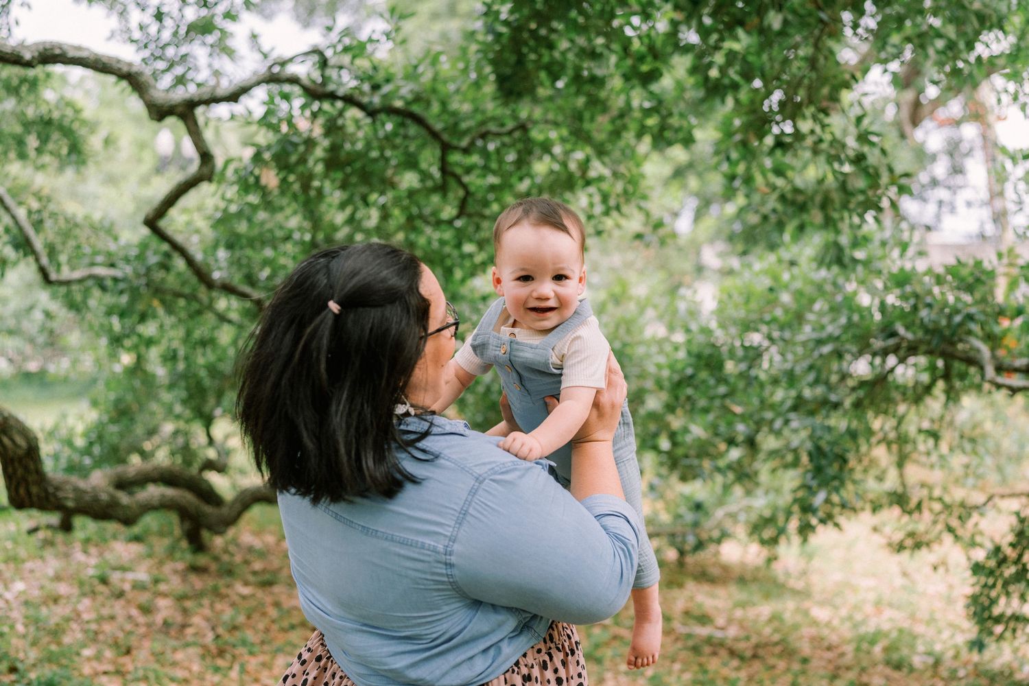 Joyful interaction captured under sprawling oak trees.