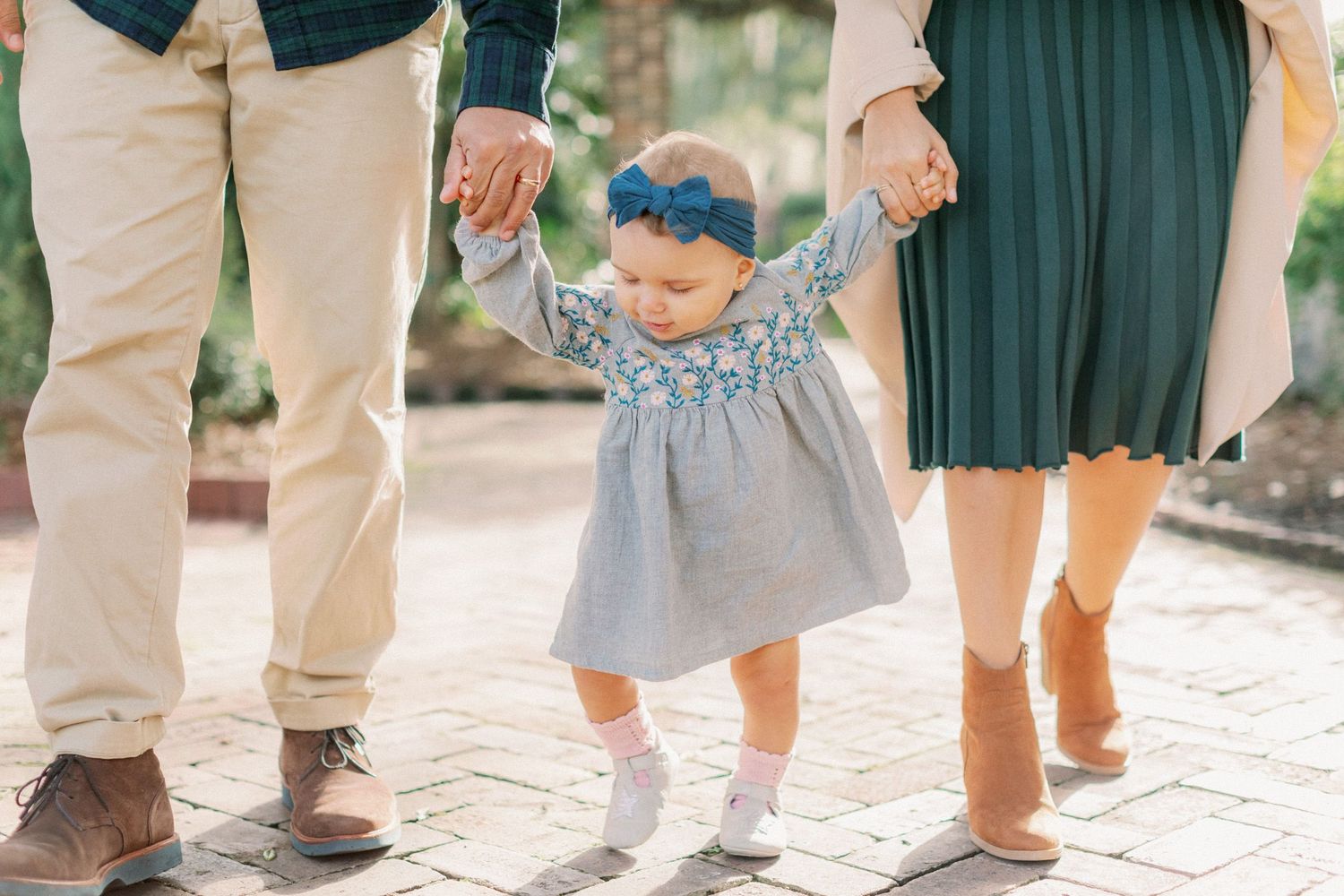 Close-up shots of feet walking together on a brick pathway showing coordinated family movement.