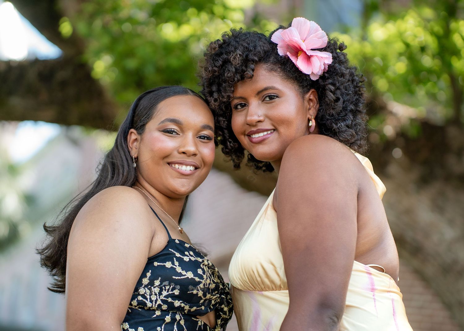 Intimate couple portraits with coordinated outfits in a sunny outdoor setting.