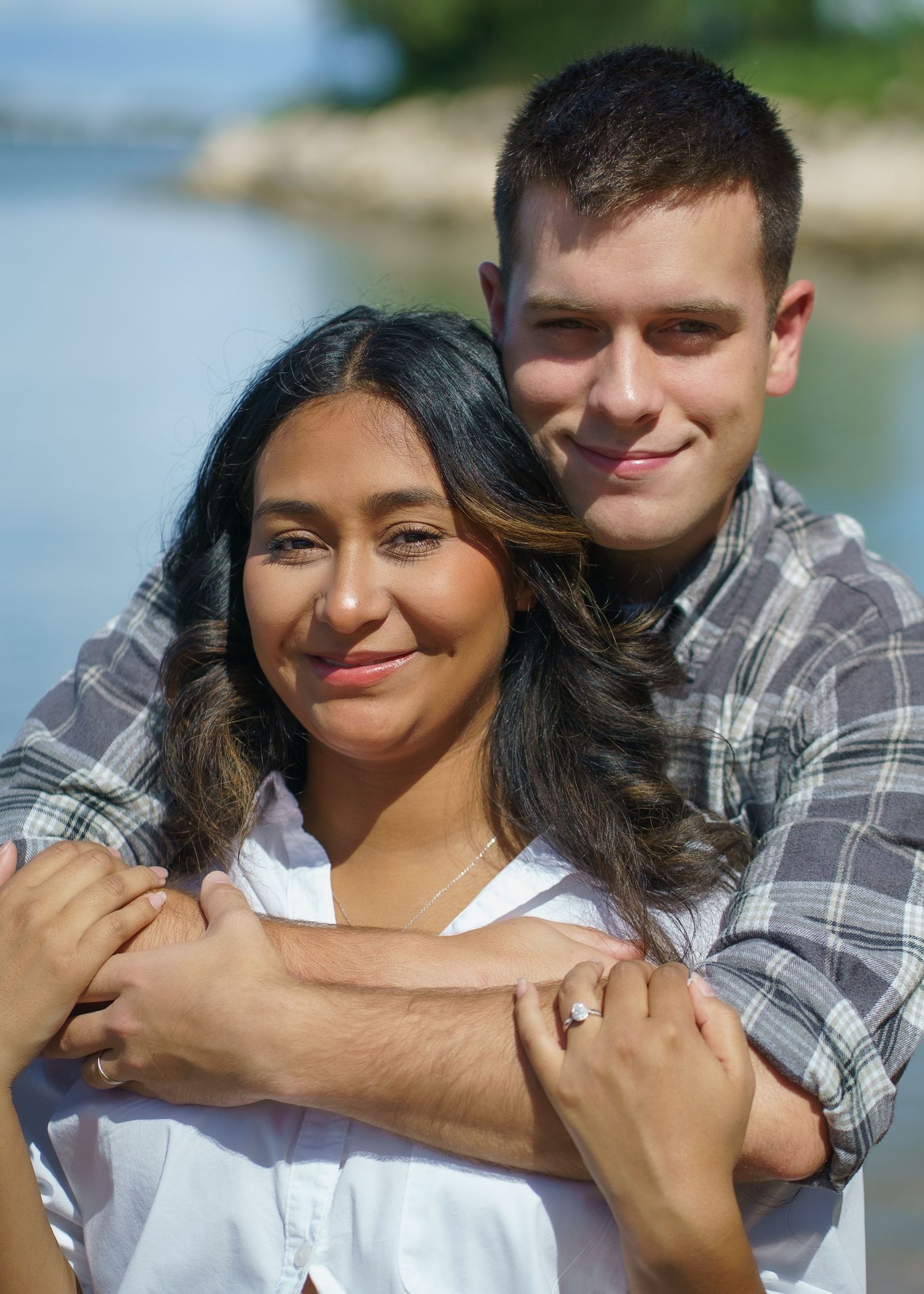 A couple shares tender moments during an outdoor photoshoot.