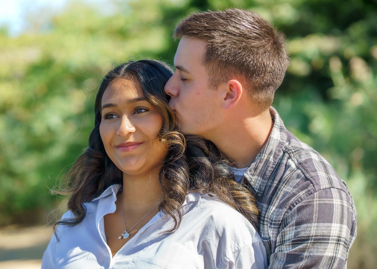 Sweet candid moments between a couple during an outdoor photoshoot.