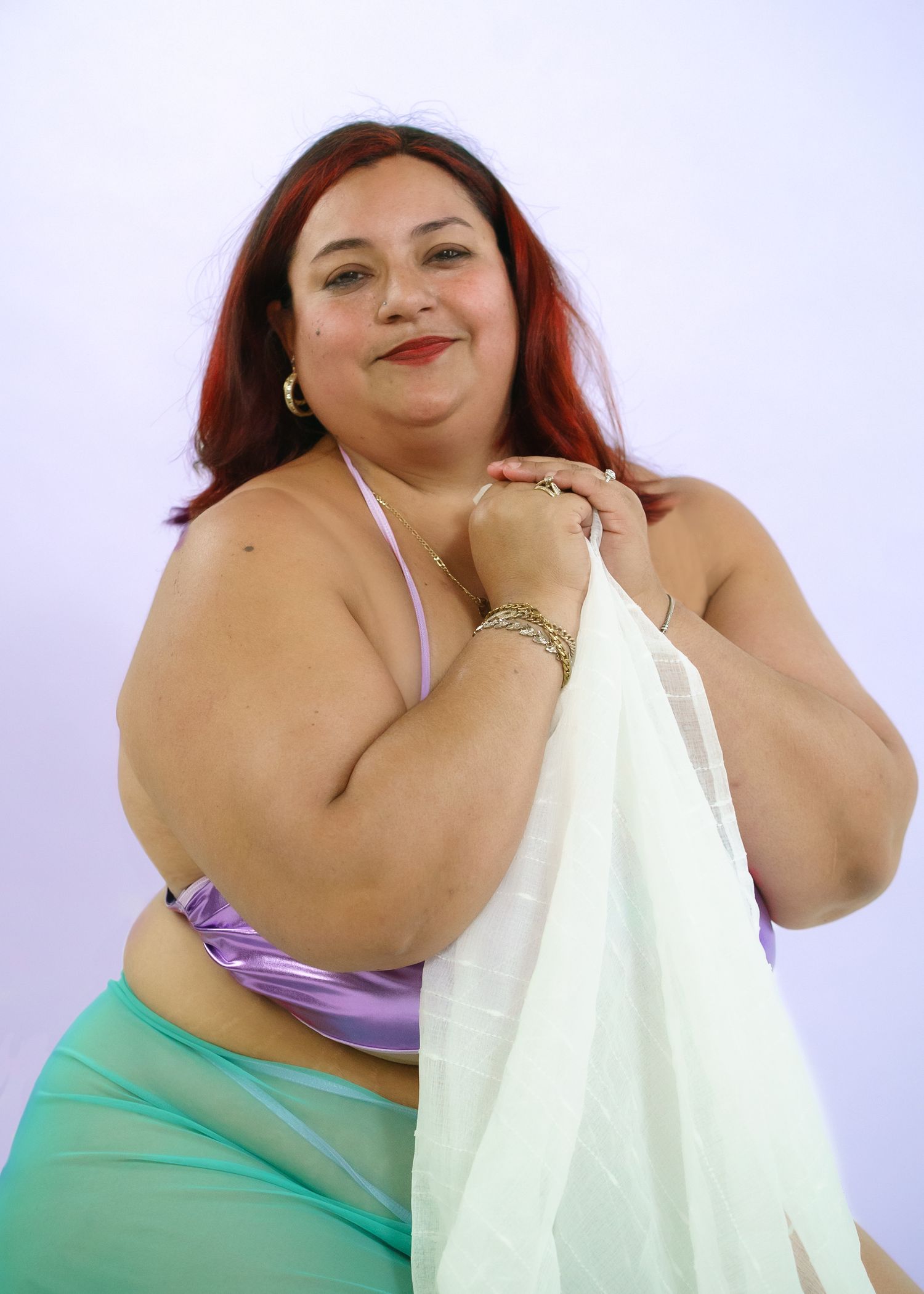 Studio portrait session with white and mint green wardrobe styling.