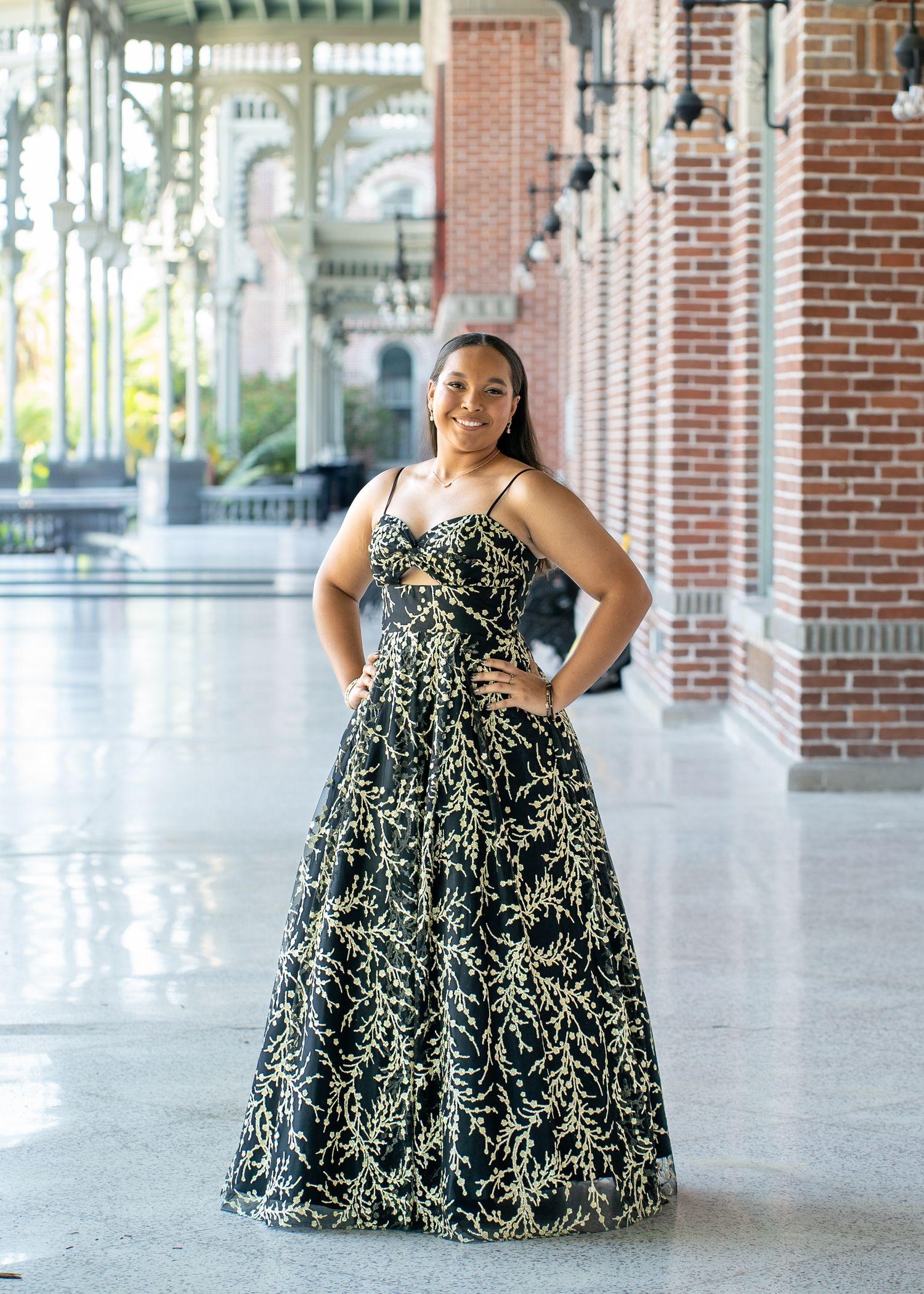 A series of fashion portraits taken in an elegant brick colonnade with natural lighting.