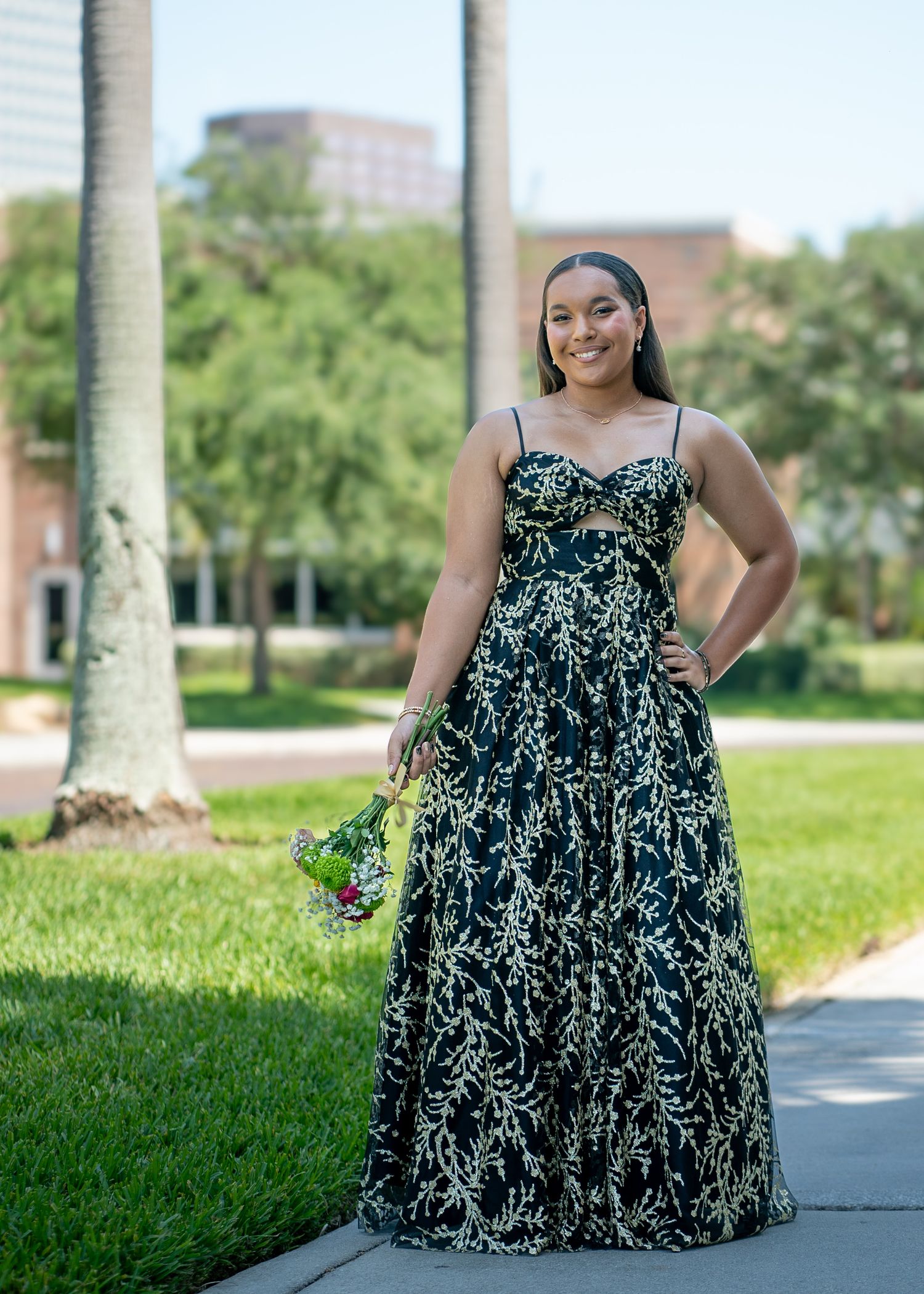 A black and white patterned maxi dress shown in different poses on a sunny lawn.