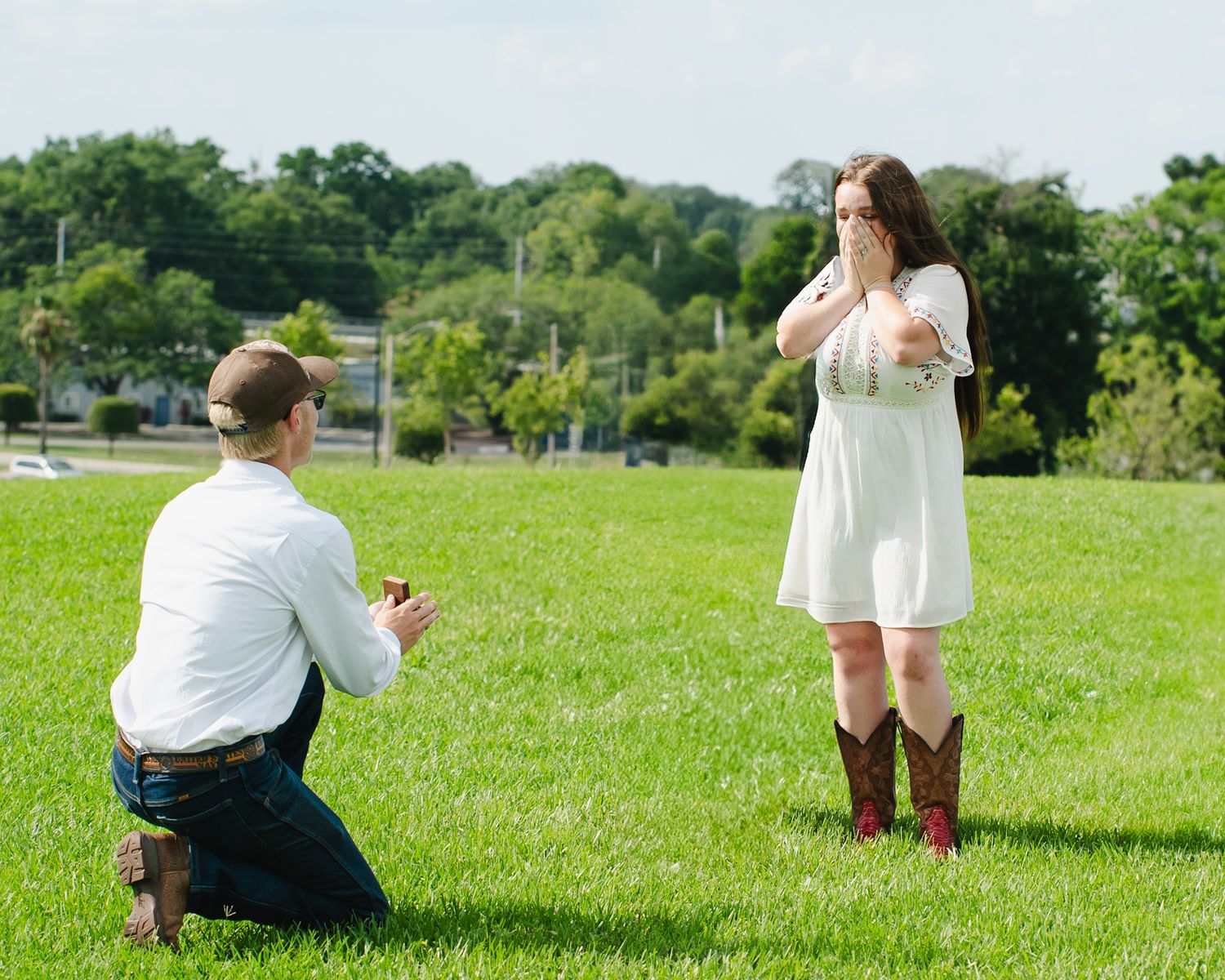 People gathered in a lush green field on a sunny summer day.