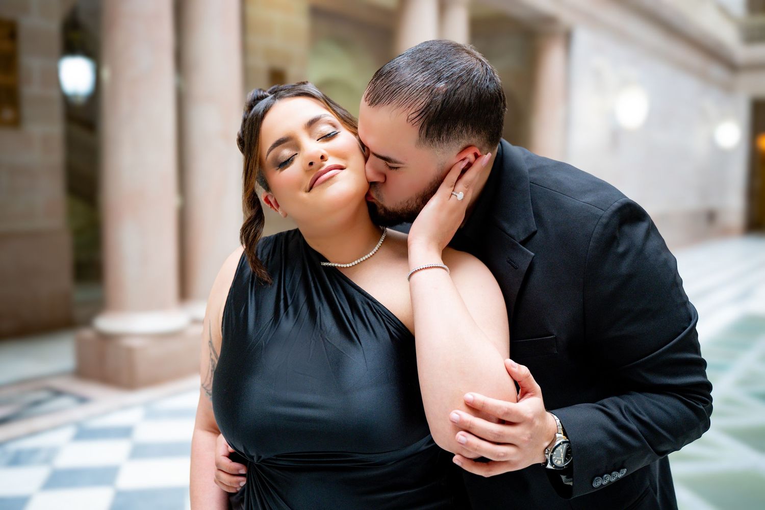 Romantic couple sharing tender moment in elegant indoor setting.