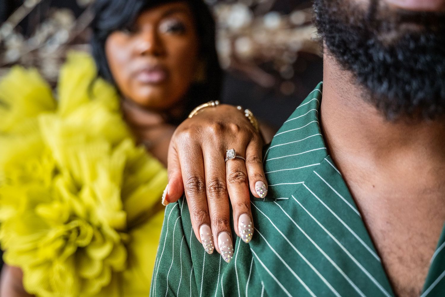 Close-up shot of a couple sharing an intimate moment against a dark background.