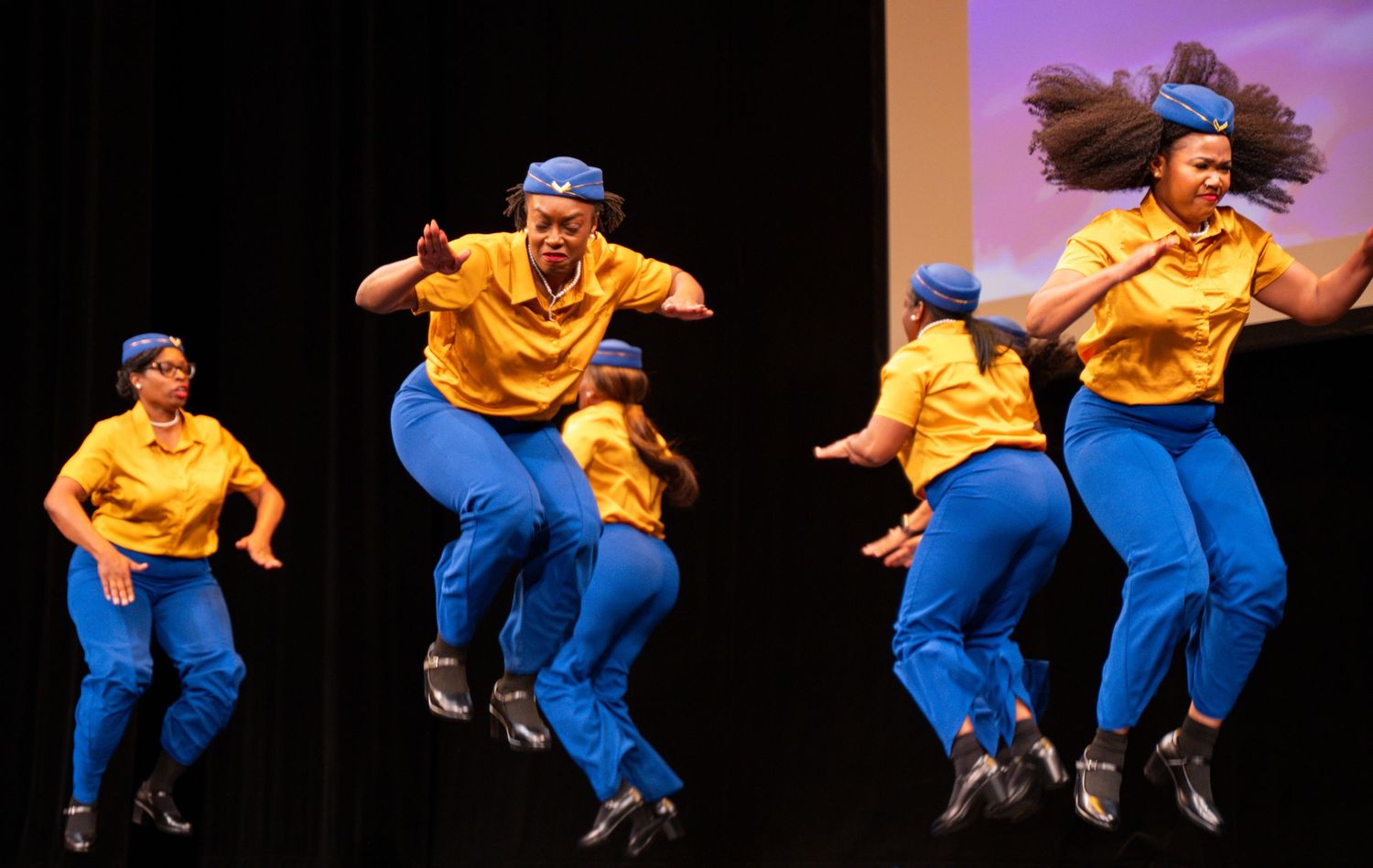 A sequence of dance movements showing a performer in yellow shirt and blue pants leaping and spinning through the air.