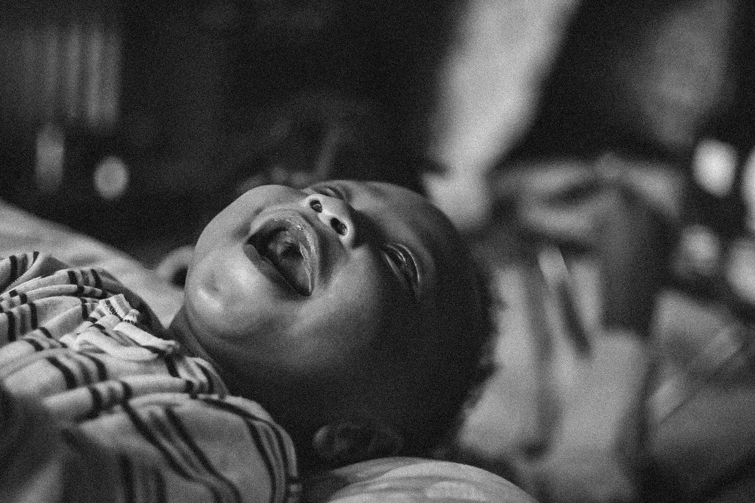Dramatic black and white close-up portraits showing range of emotions.