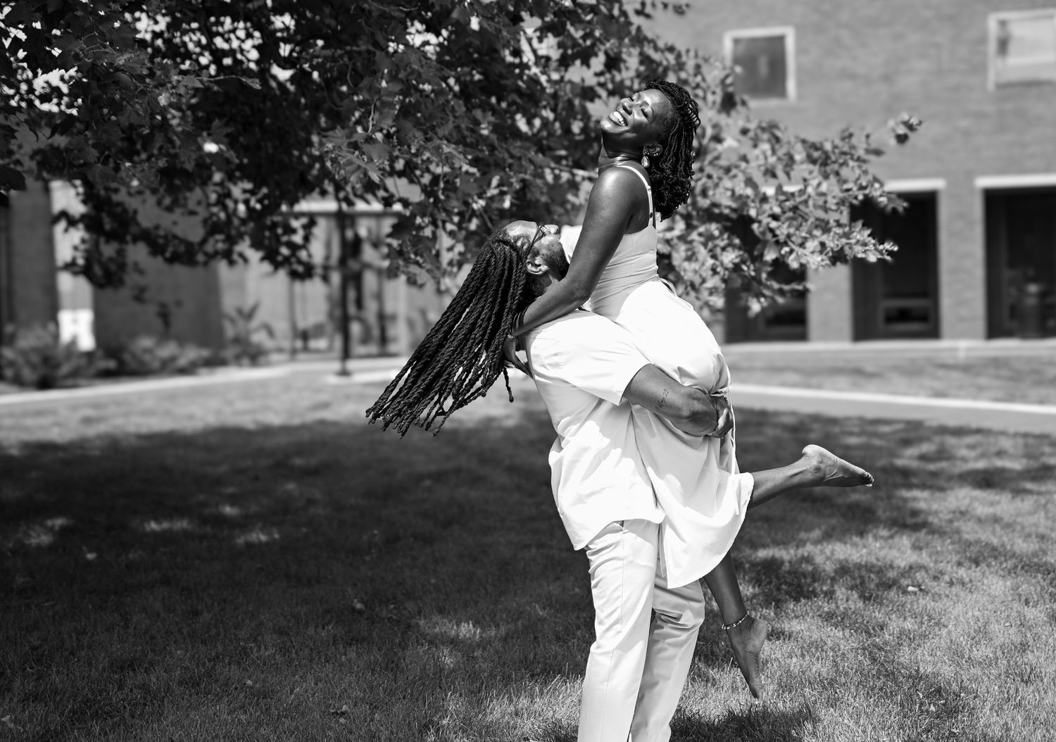 A sequence of black and white photos showing someone performing a cartwheel on grass with trees in the background.