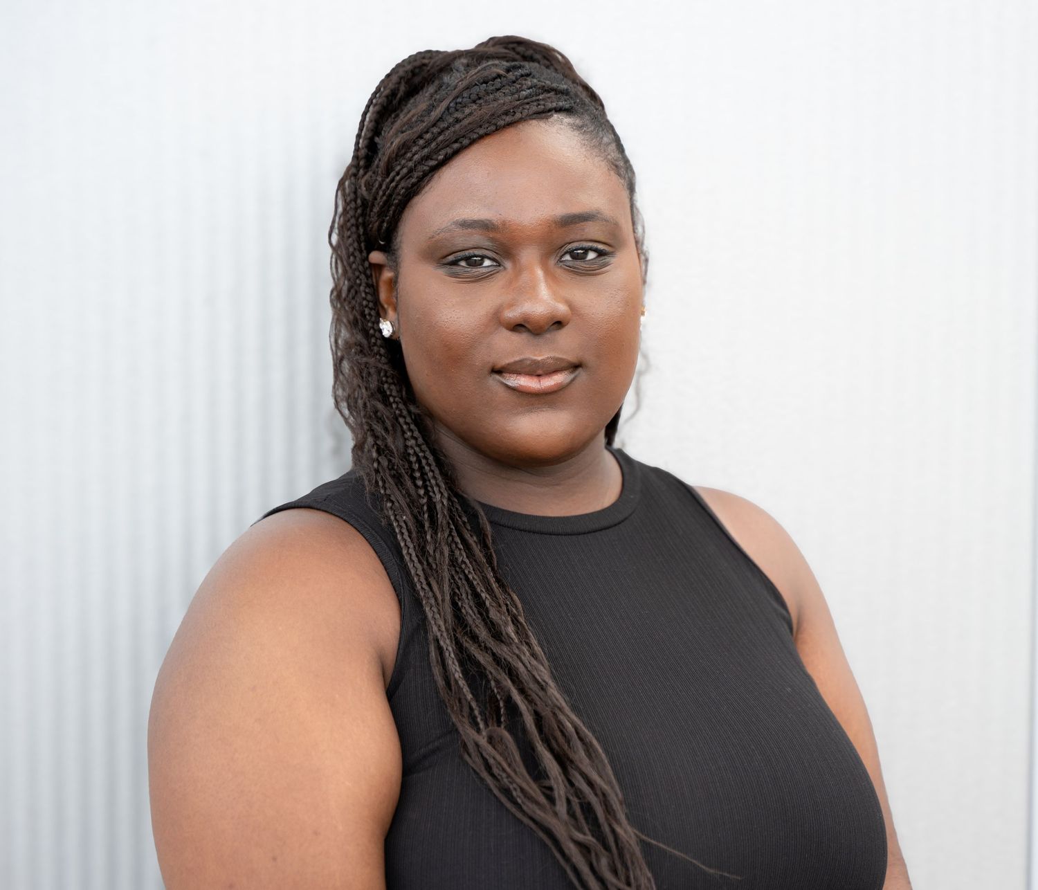 Portrait headshots showing a person in a black sleeveless top against a white background.