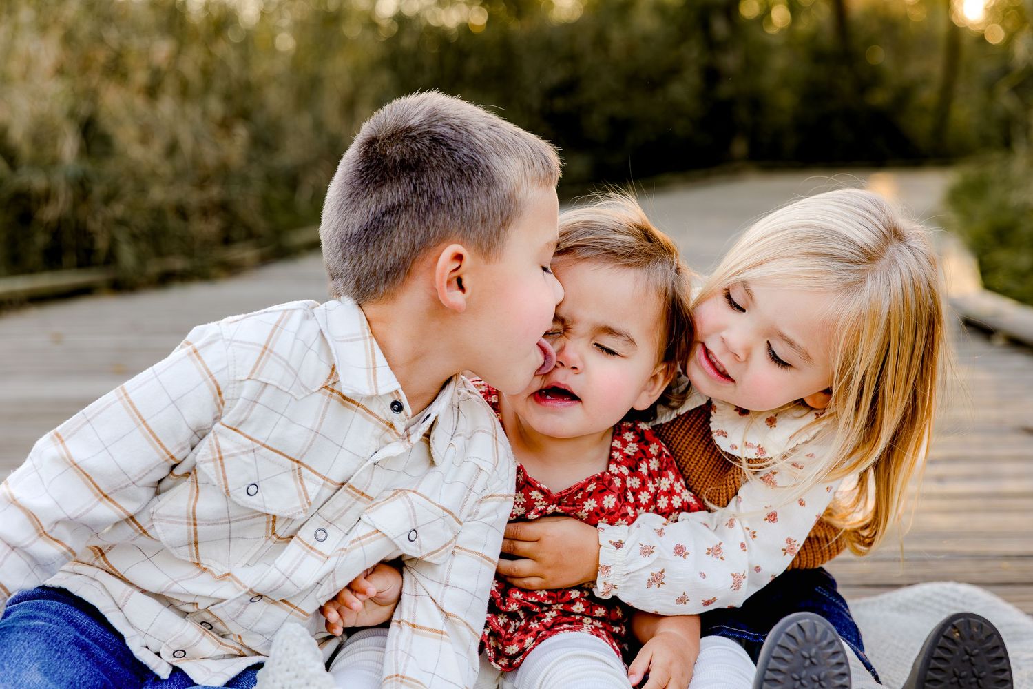 Children playing and laughing together outdoors during golden hour sunset.