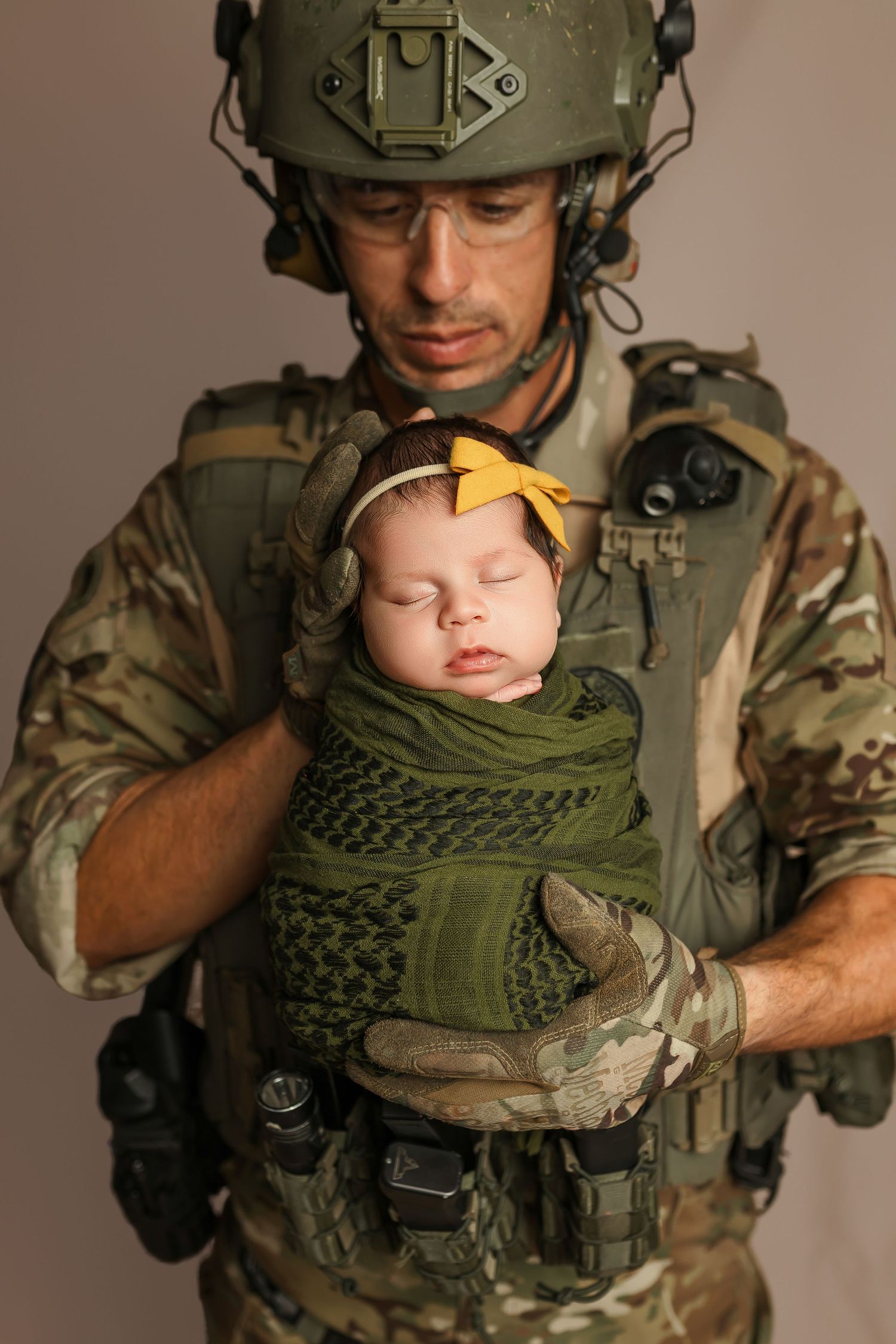 father holding newborn baby portrait honoring military family