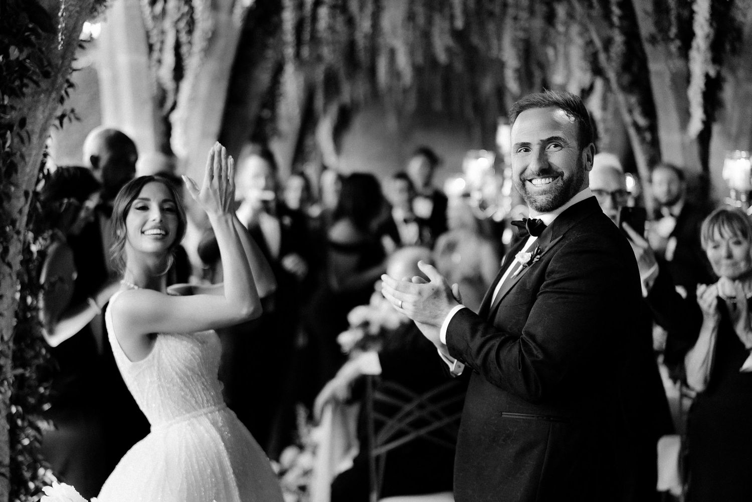 A couple dances and celebrates during their wedding reception at an elegant venue.