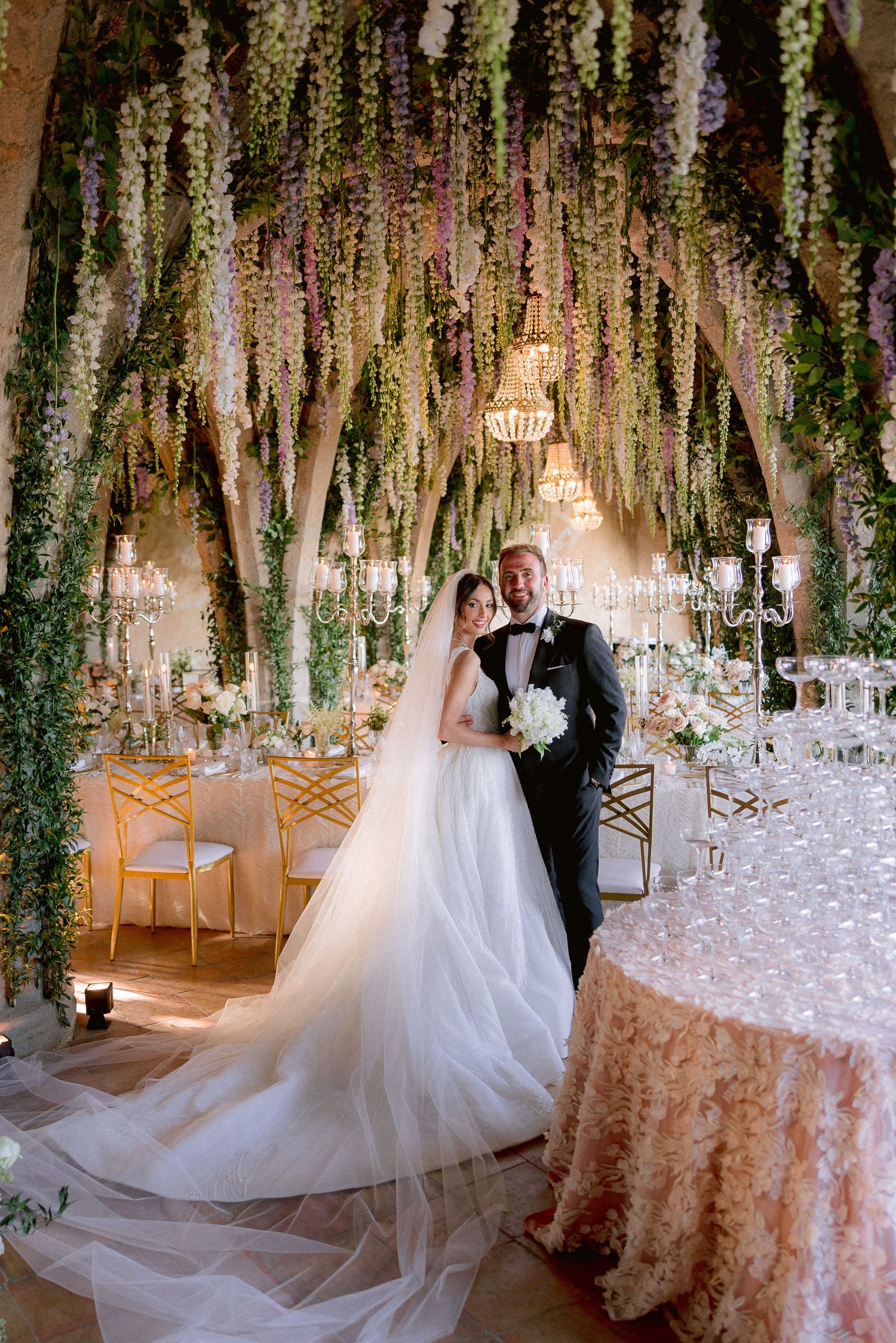 The crypt of Villa Cimbone decorated with cascading floral installations, crystal chandeliers and lace-covered tables.